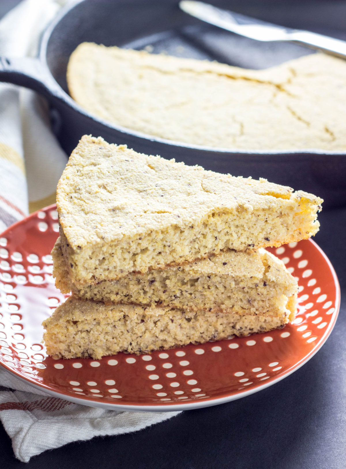 Oil Free Cornbread stacked on an orange and white plate. 