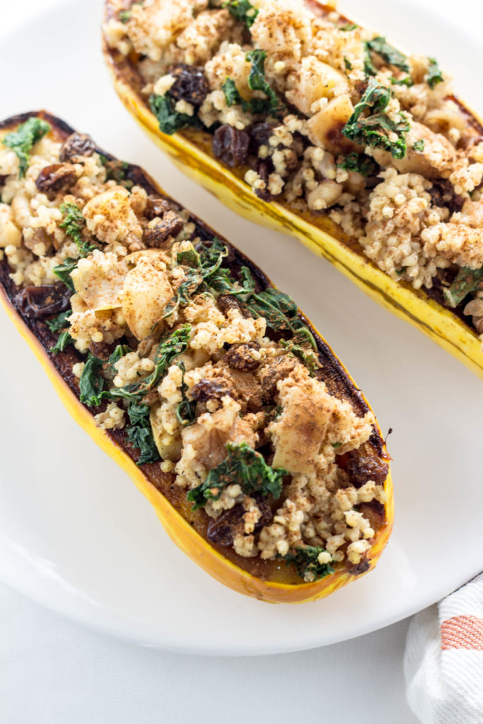Millet Stuffed Delicata Squash-made with apples, kale, raisins, cinnamon and more for a ton of delicious flavor. A meal the whole family will love.