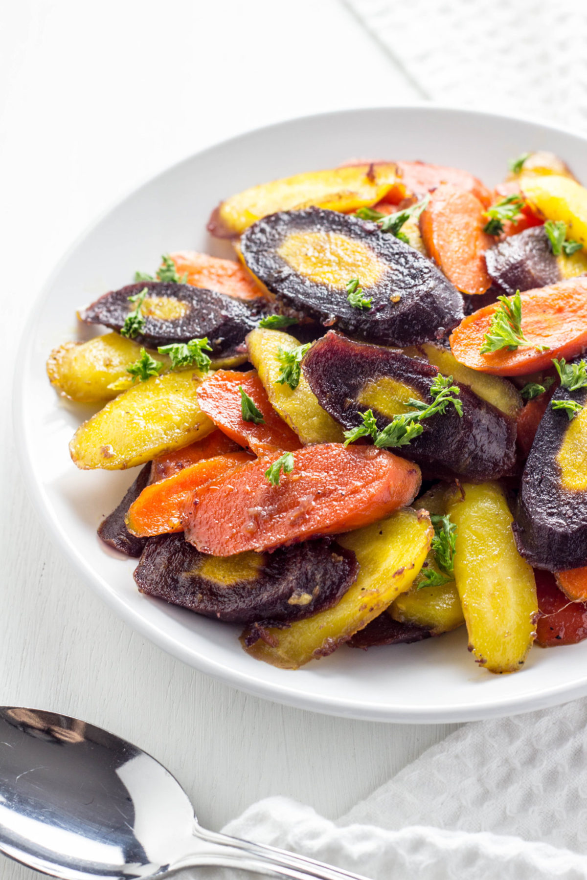 Close up side view of Maple Ginger Roasted Rainbow Carrots. 