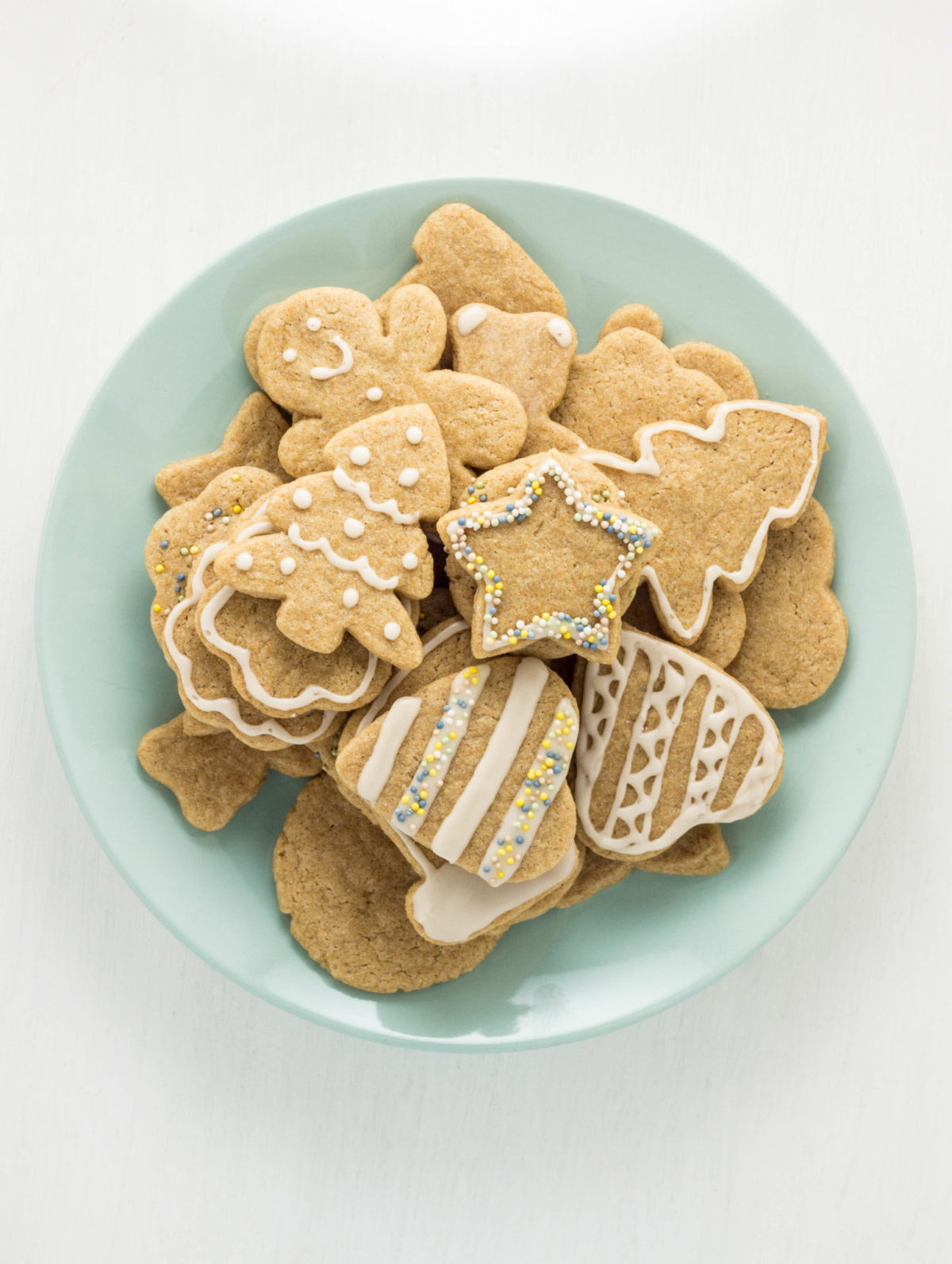 Top view of a plate of cut out cookies. 