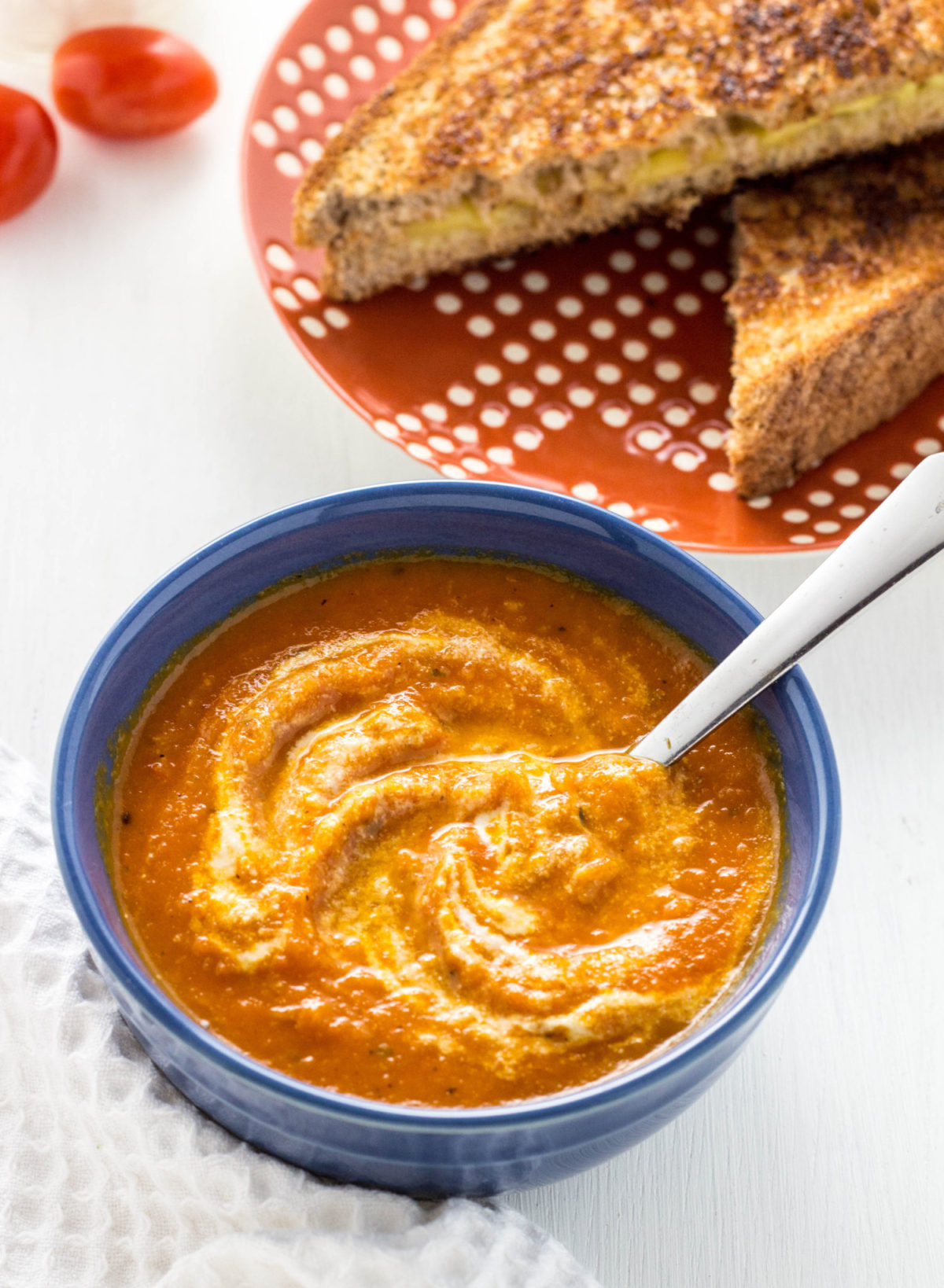 Creamy Roasted Tomato Soup in a blue bowl. 