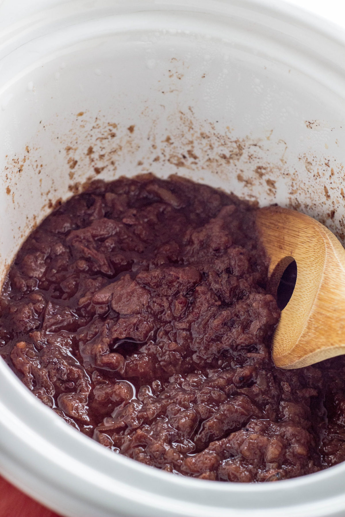 Apples and dates in slow cooker after cooking. 