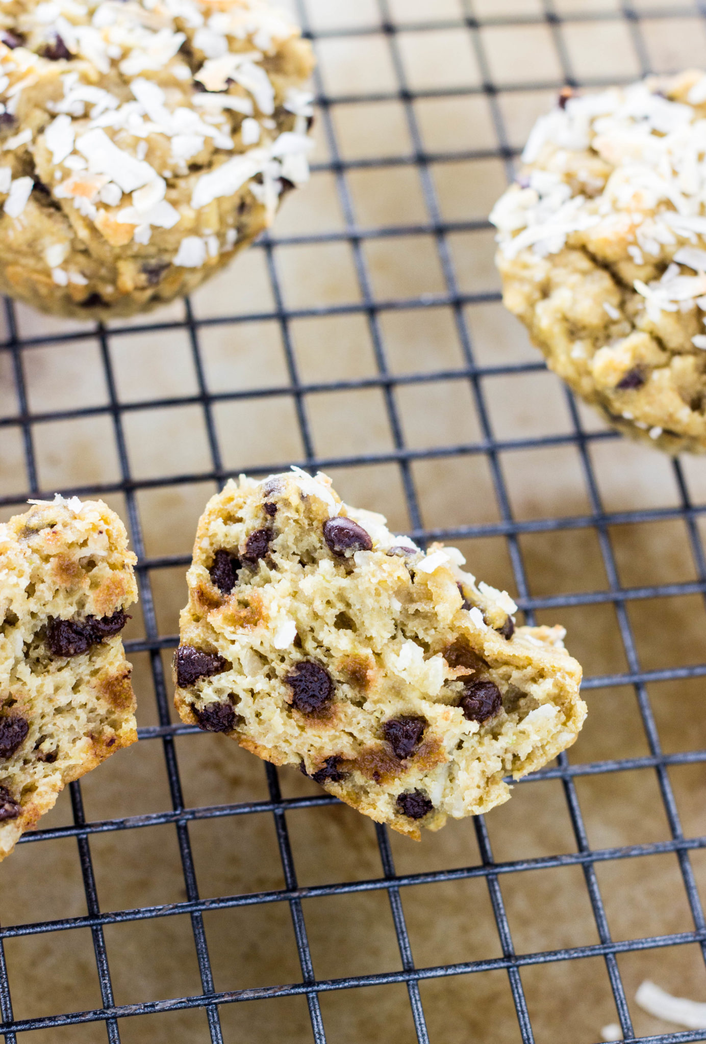 Close up of a muffin cut in half to show interior texture on a wire cooling rack.