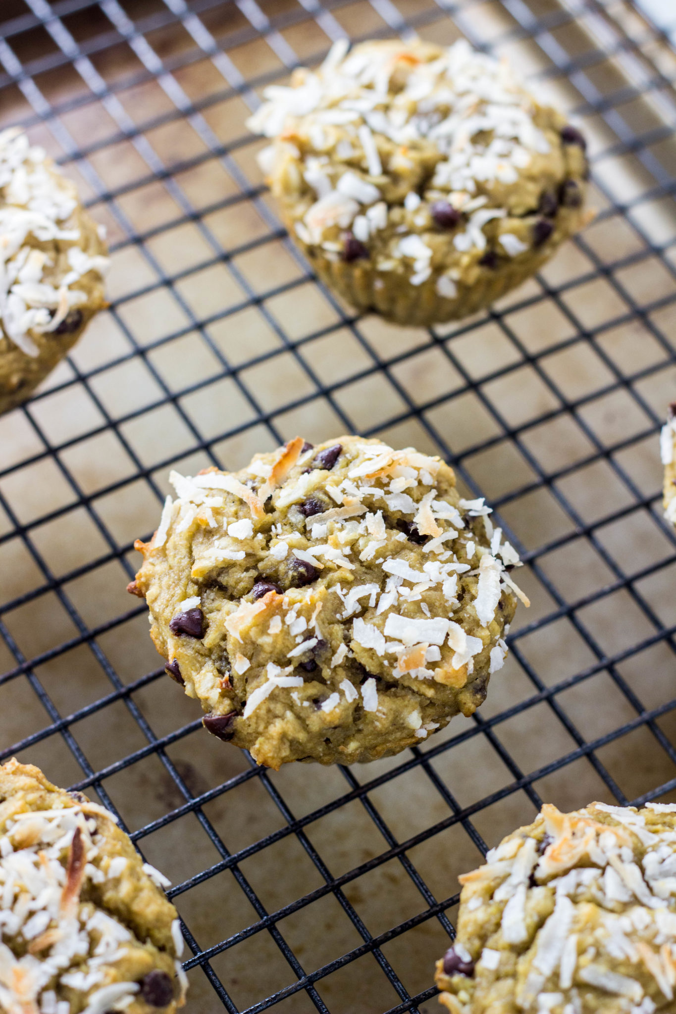 Coconut Chocolate Chip Muffins on a wire cooling rack. 