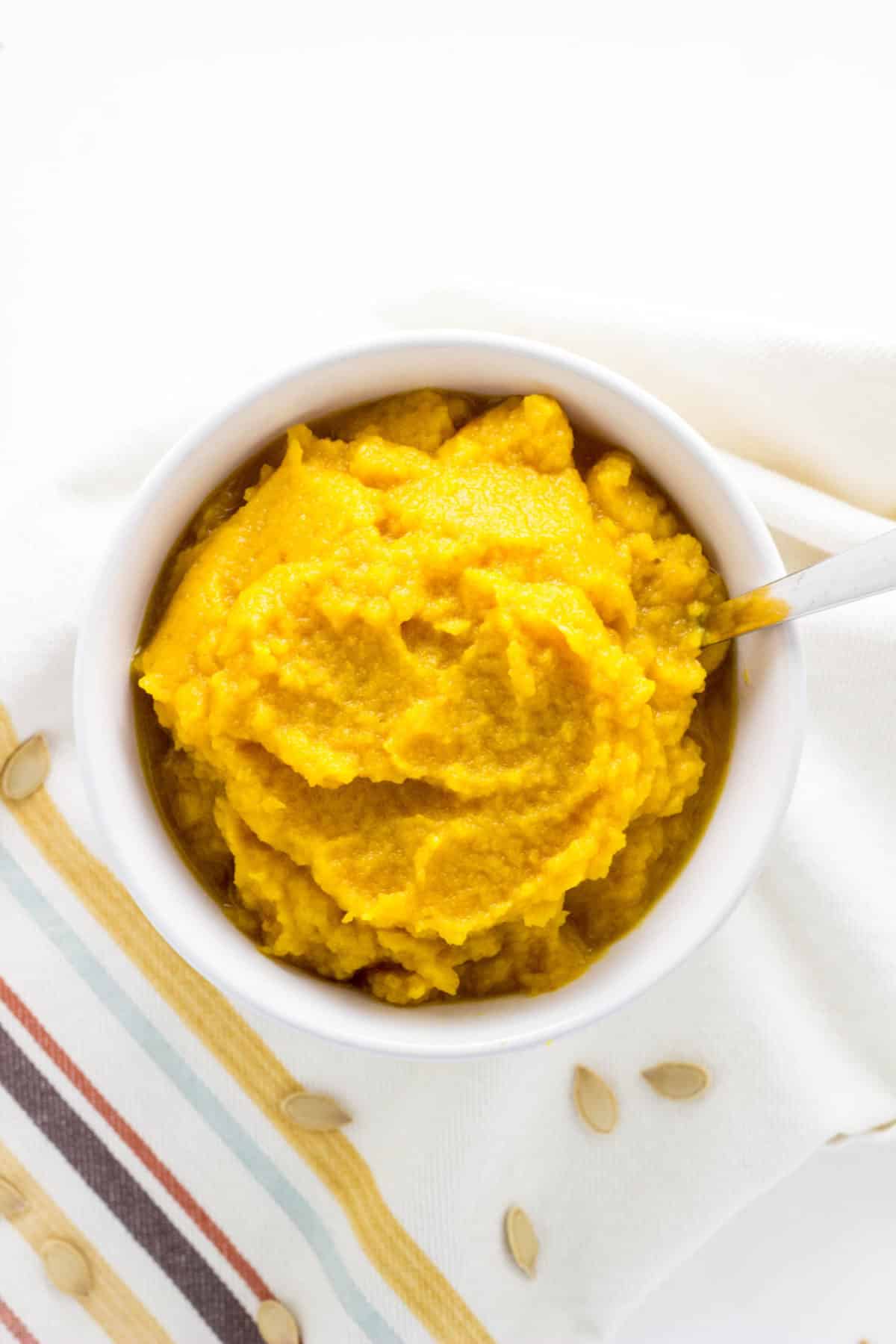 Overhead view of a small bowl of Homemade Pumpkin Puree.