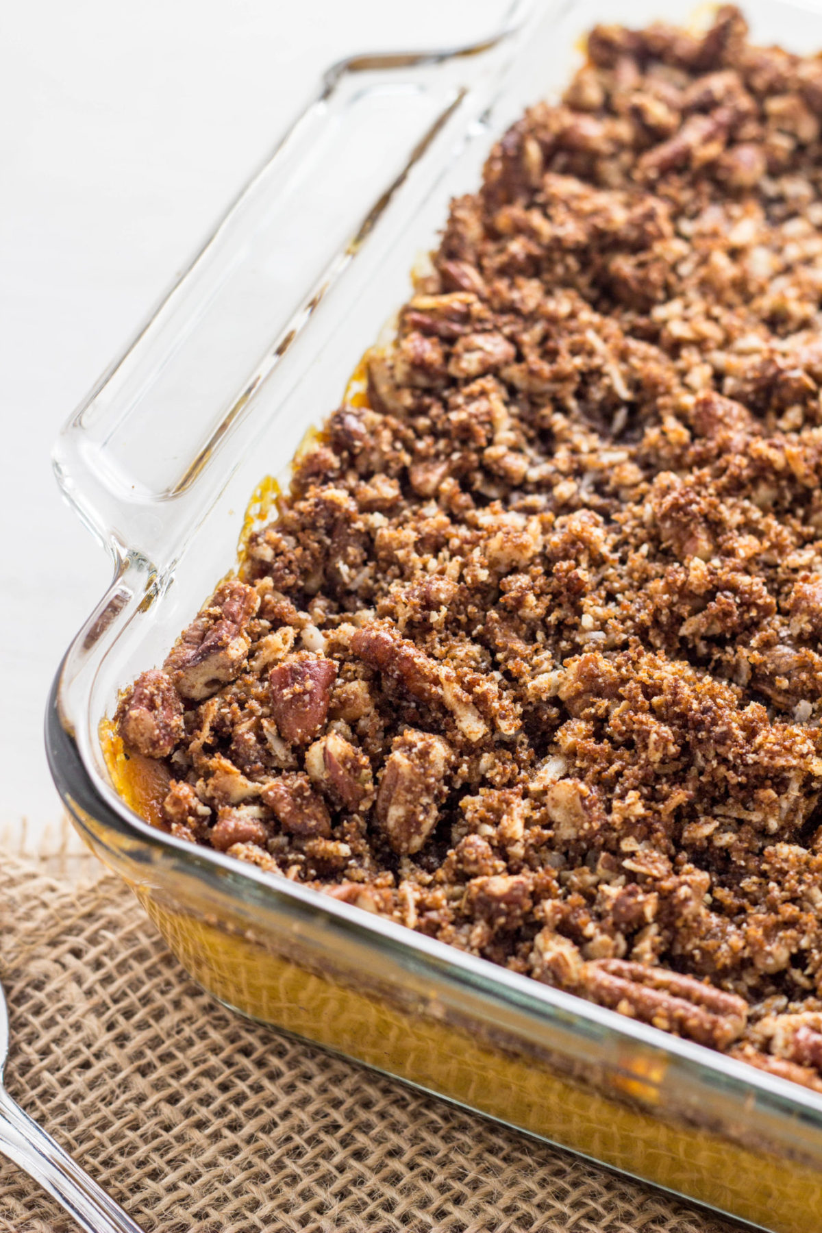 Close up side view of Vegan Sweet Potato Casserole in a glass baking dish. 