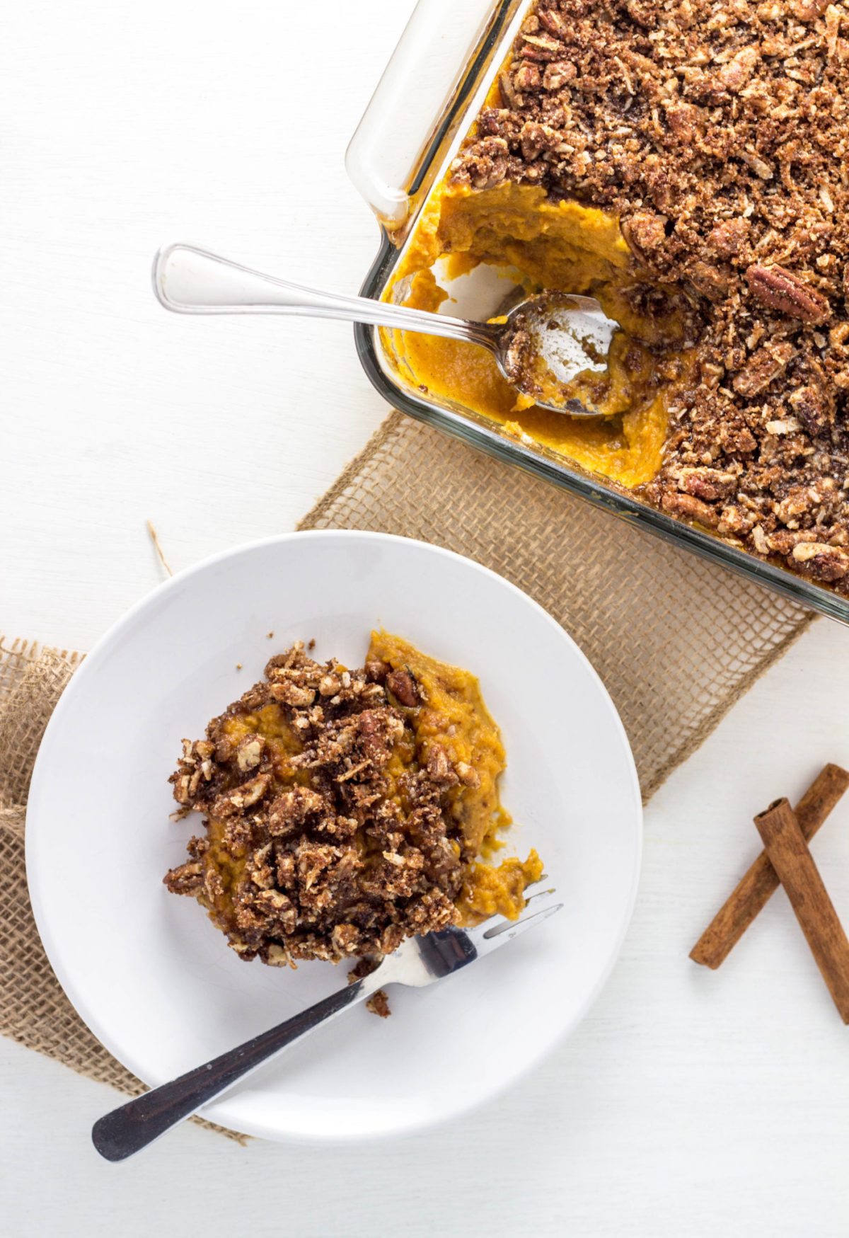 Top view of Vegan Sweet Potato Casserole on a white plate with a fork. 