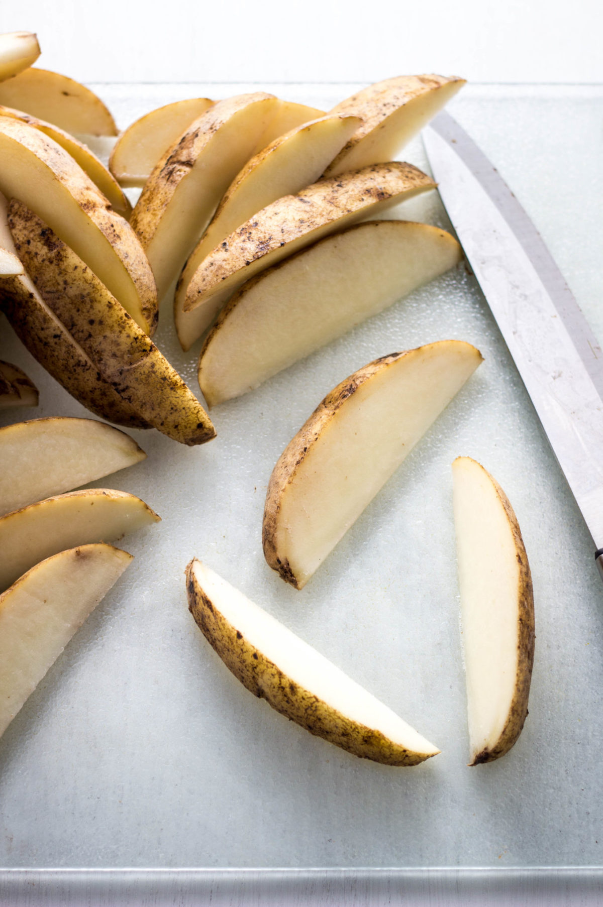 Potatoes sliced into wedges. 