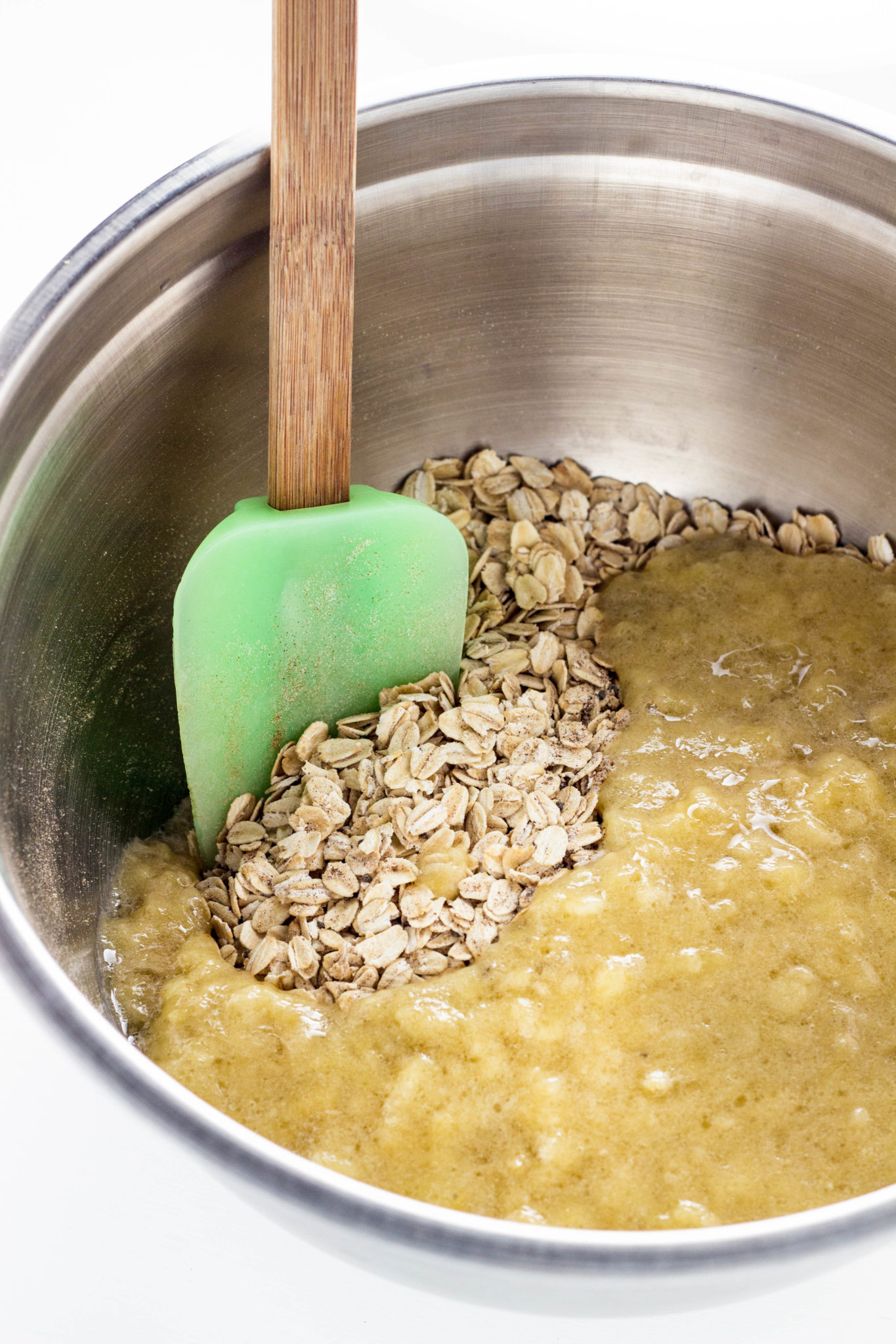 Oats with mashed bananas in a bowl before mixing. 