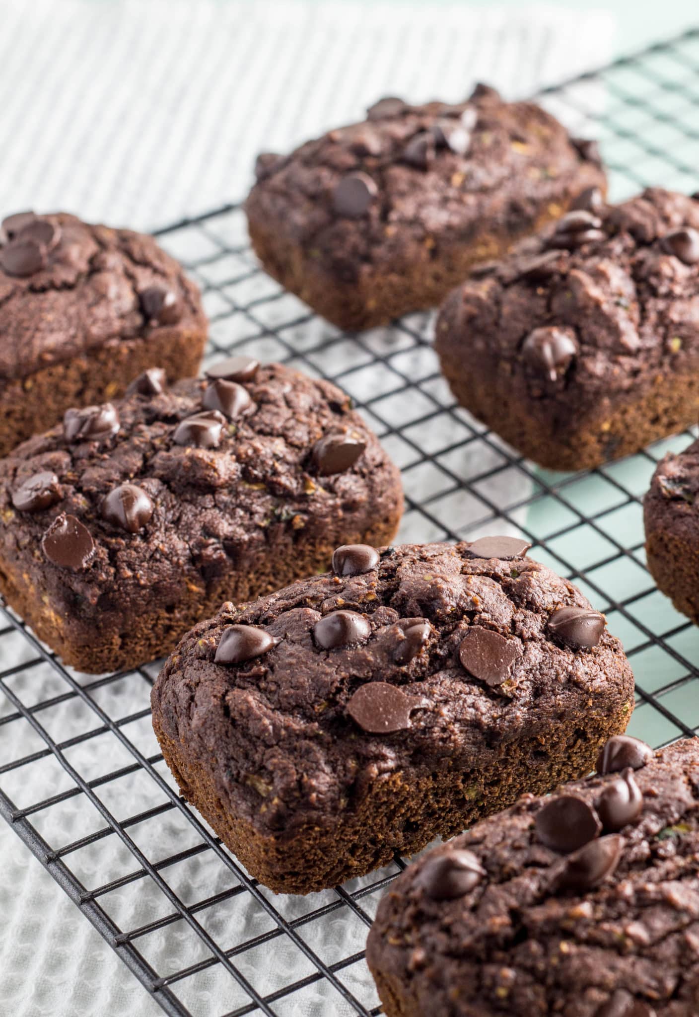 Chocolate Zucchini Bread Mini Loaves on a wire cooling rack.
