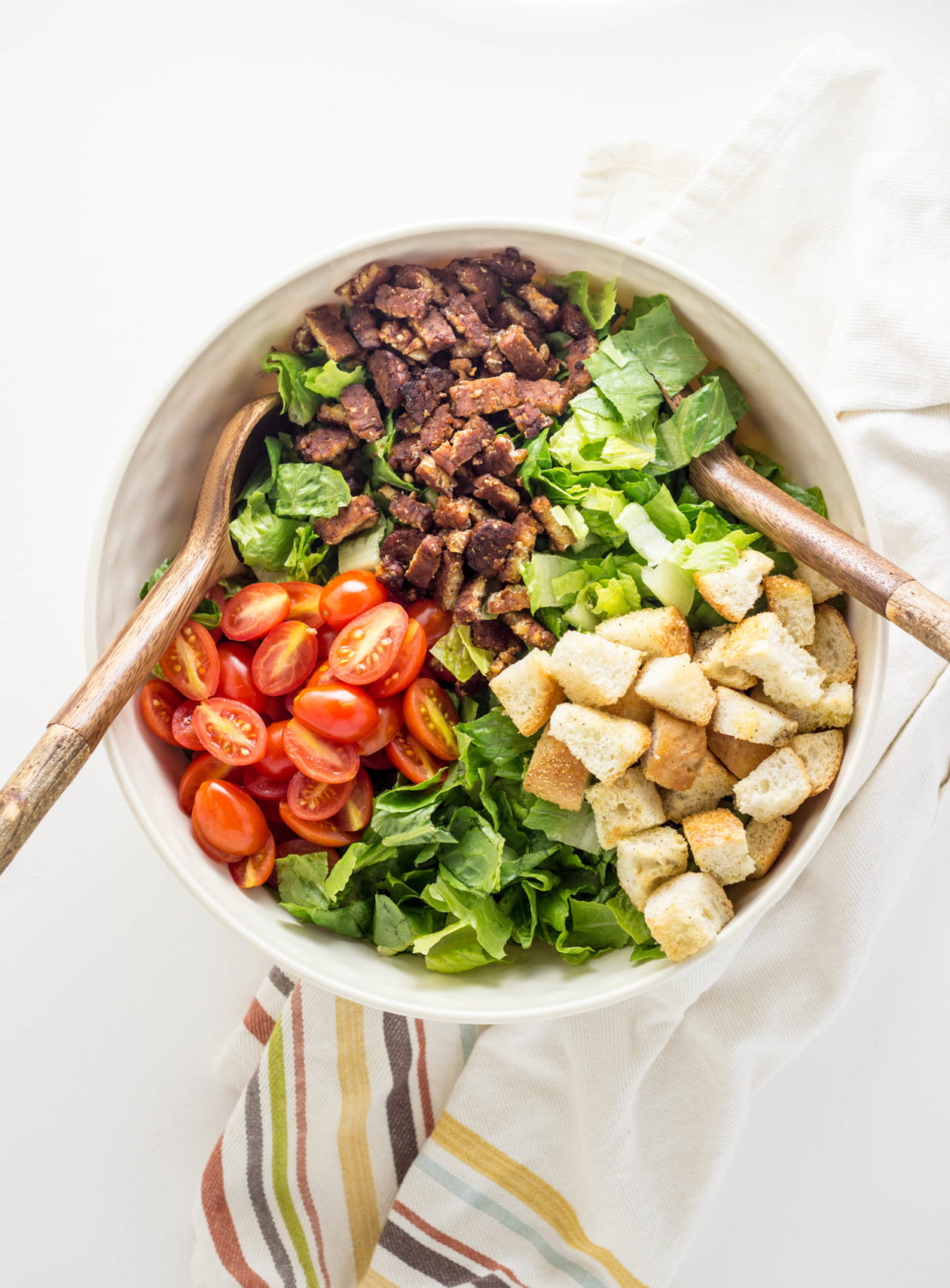 Top view of Vegan BLT Salad ingredients in large bowl before being tossed together. 