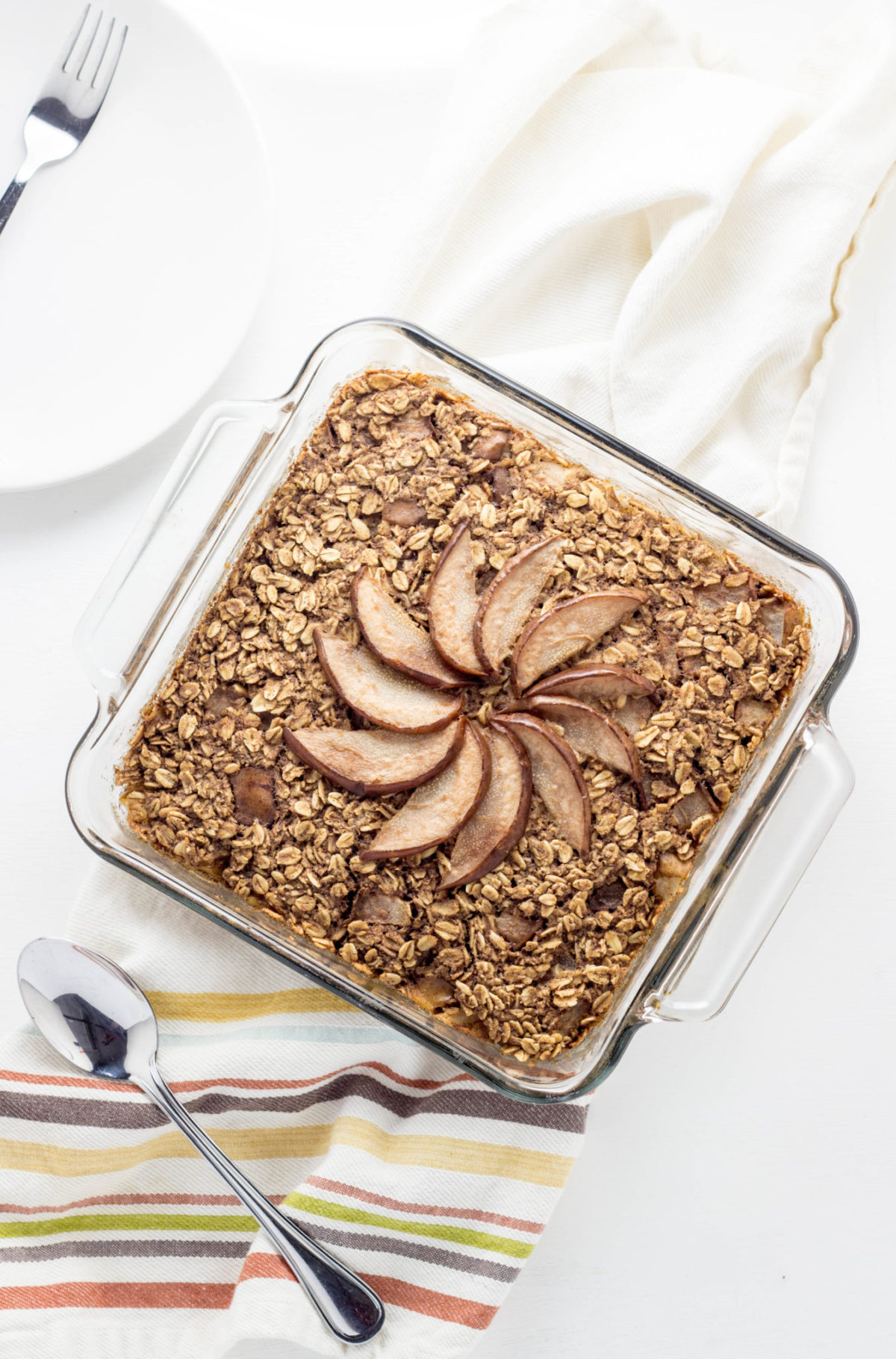 Top view of Cinnamon Pear Baked Oatmeal in a square baking dish. 