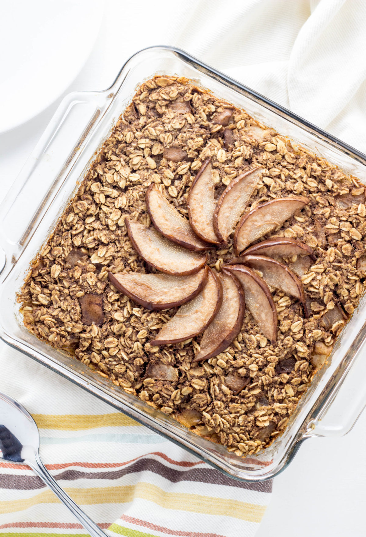 Top view close up of Cinnamon Pear Baked Oatmeal in a square baking dish.