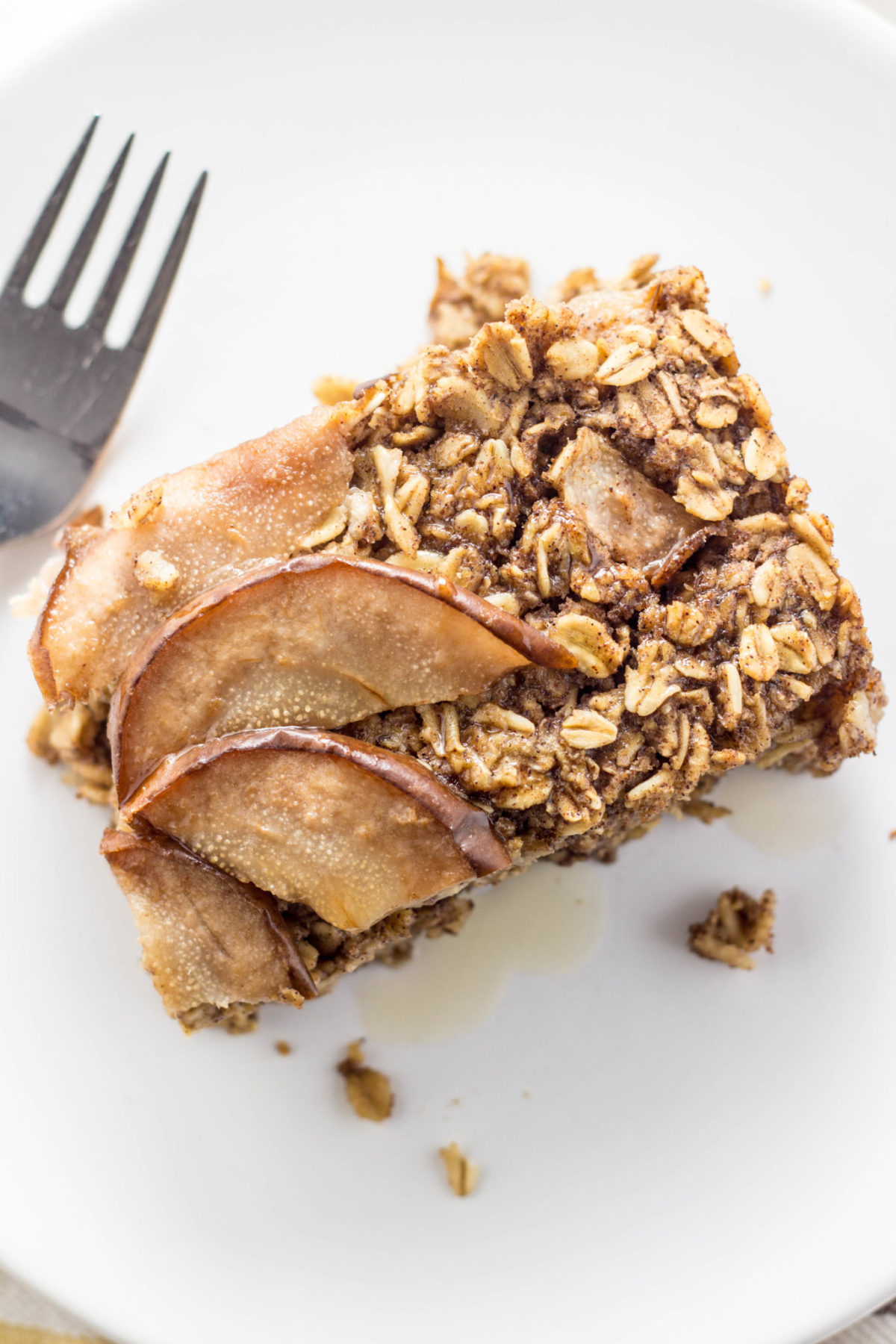 Top view close up of a serving of Cinnamon Pear Baked Oatmeal on a white plate.