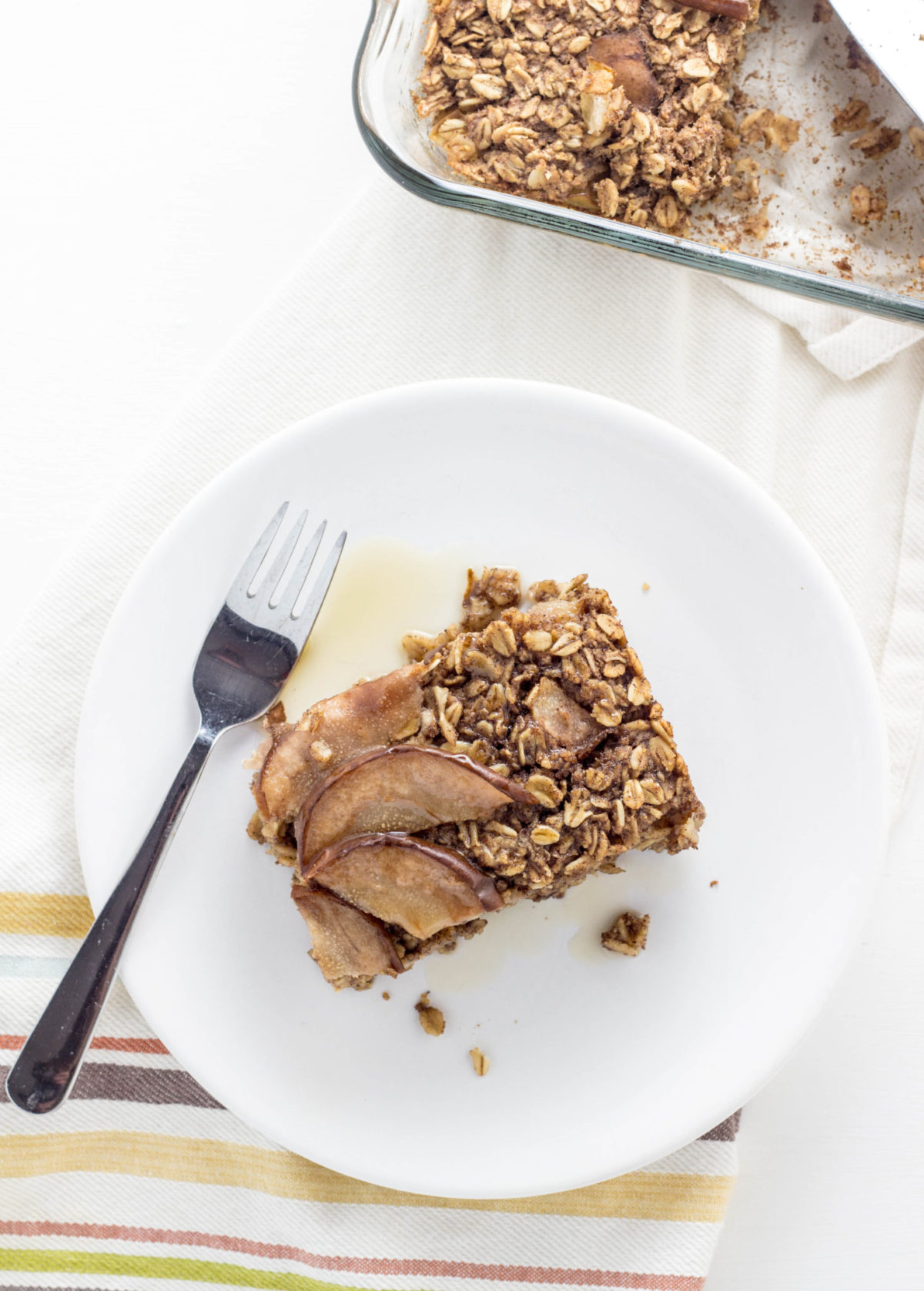 Top view of Cinnamon Pear Baked Oatmeal on a white plate. 