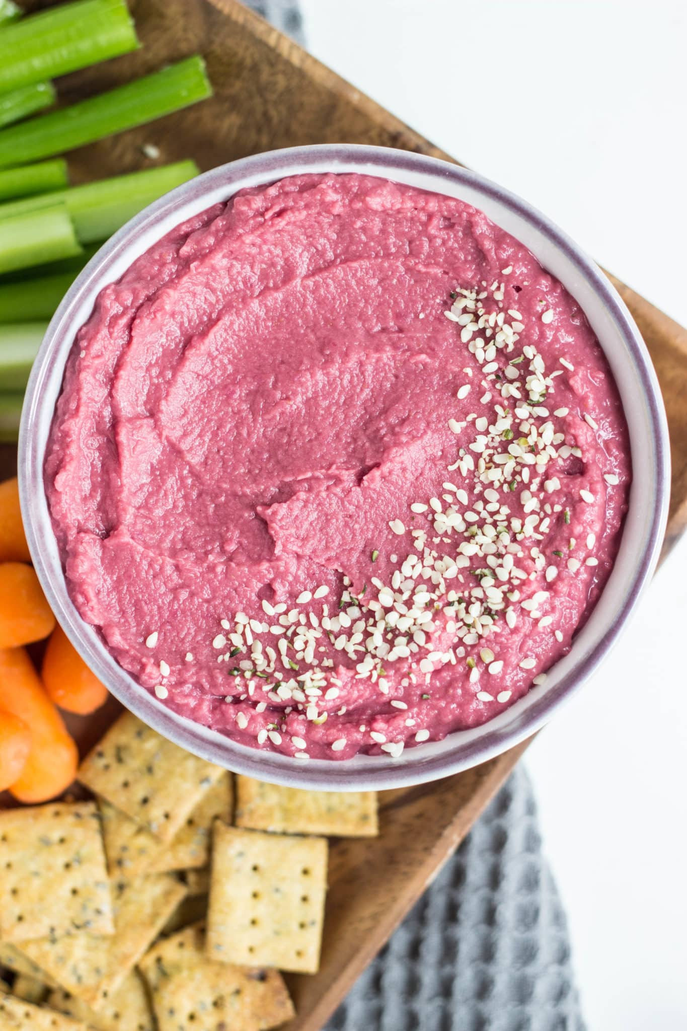 Overhead shot of 5 minute Vegan Beetroot Bean Dip with vegetables and crackers.