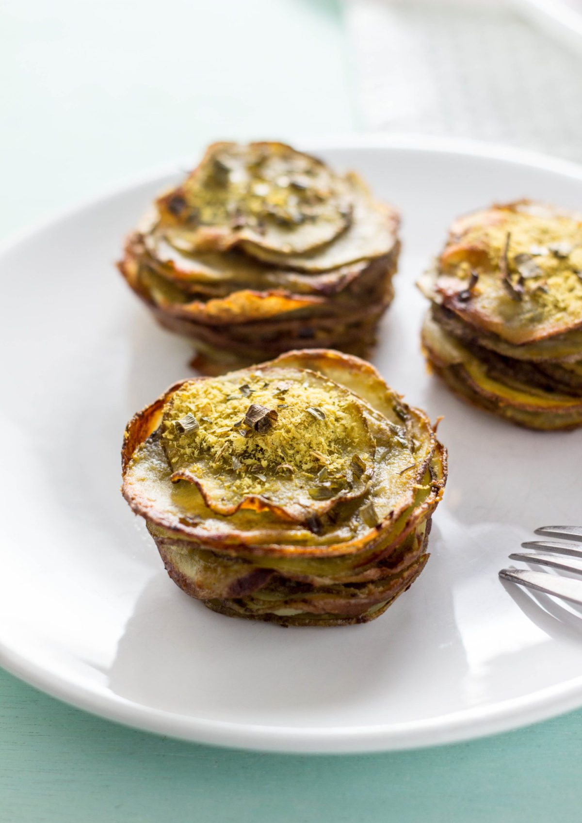 Side view of "Cheesy" Potato Stacks on white plate. 