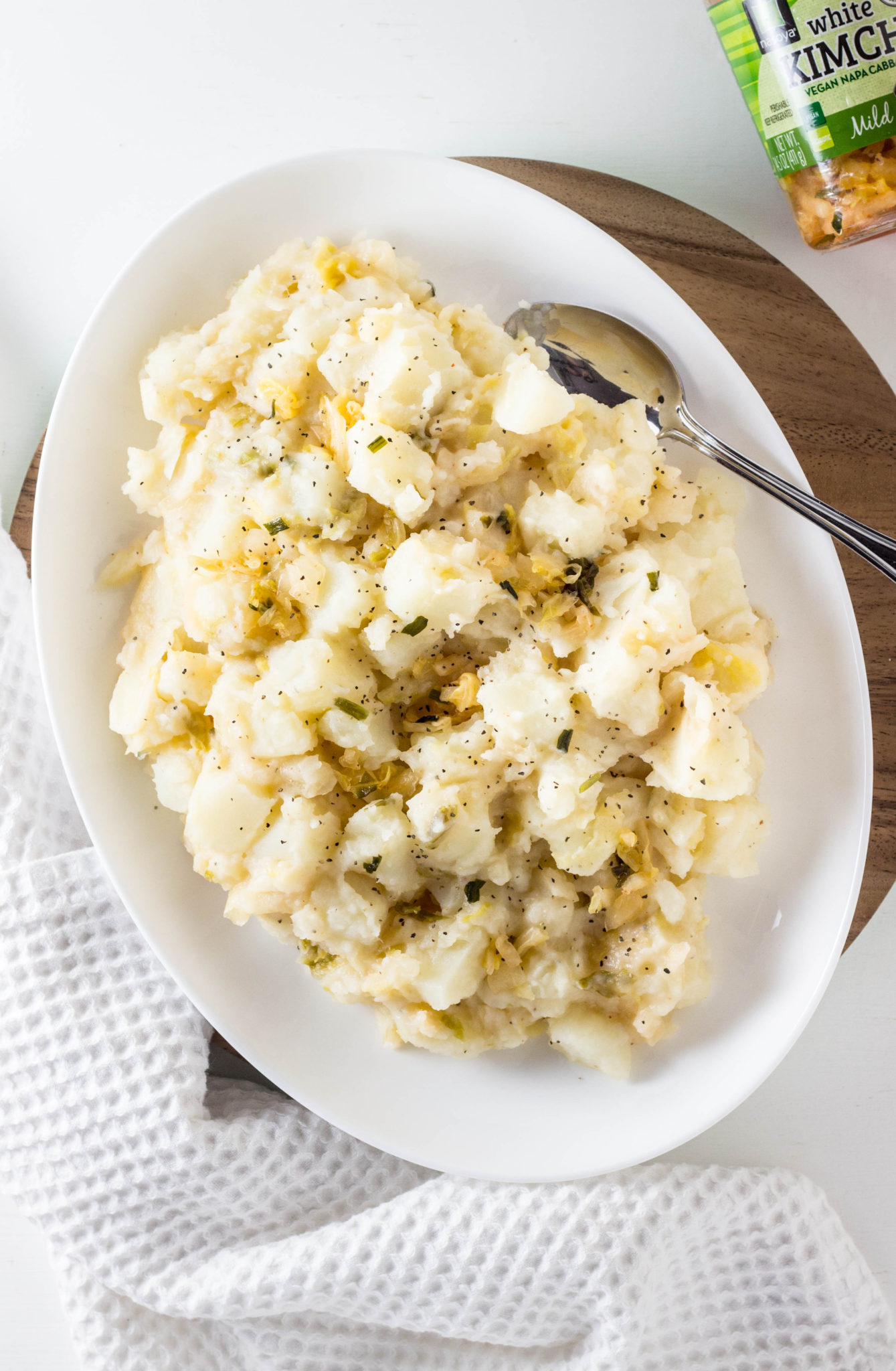 Top view of Vegan Kimchi Potato Salad on a white serving platter. 