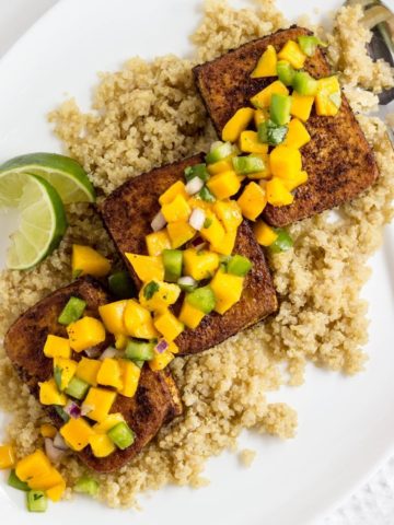 Top view of Spiced Tofu on a bed of quinoa and topped with mango salsa.