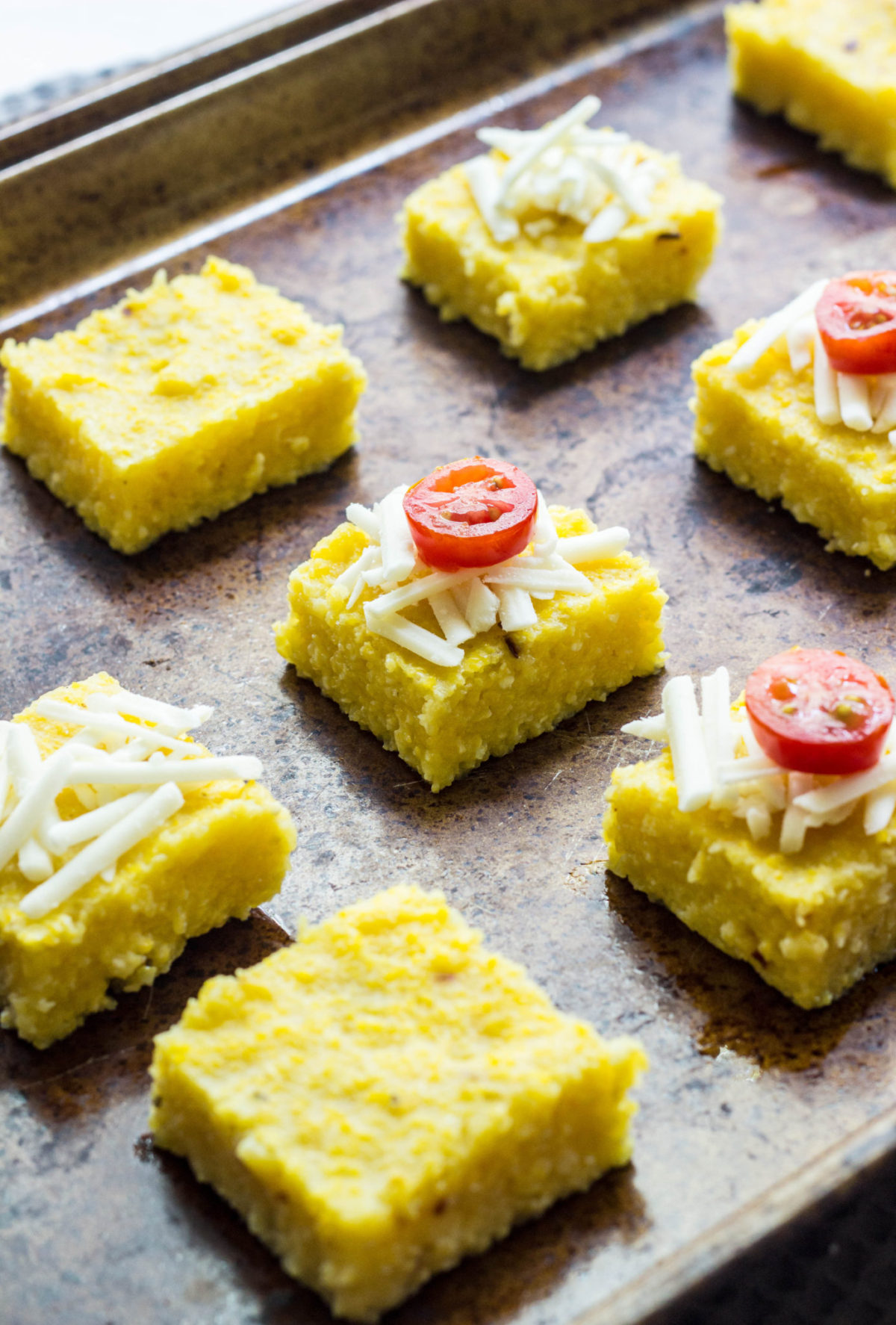 Vegan Cheesy Polenta Bites with cheese and tomato