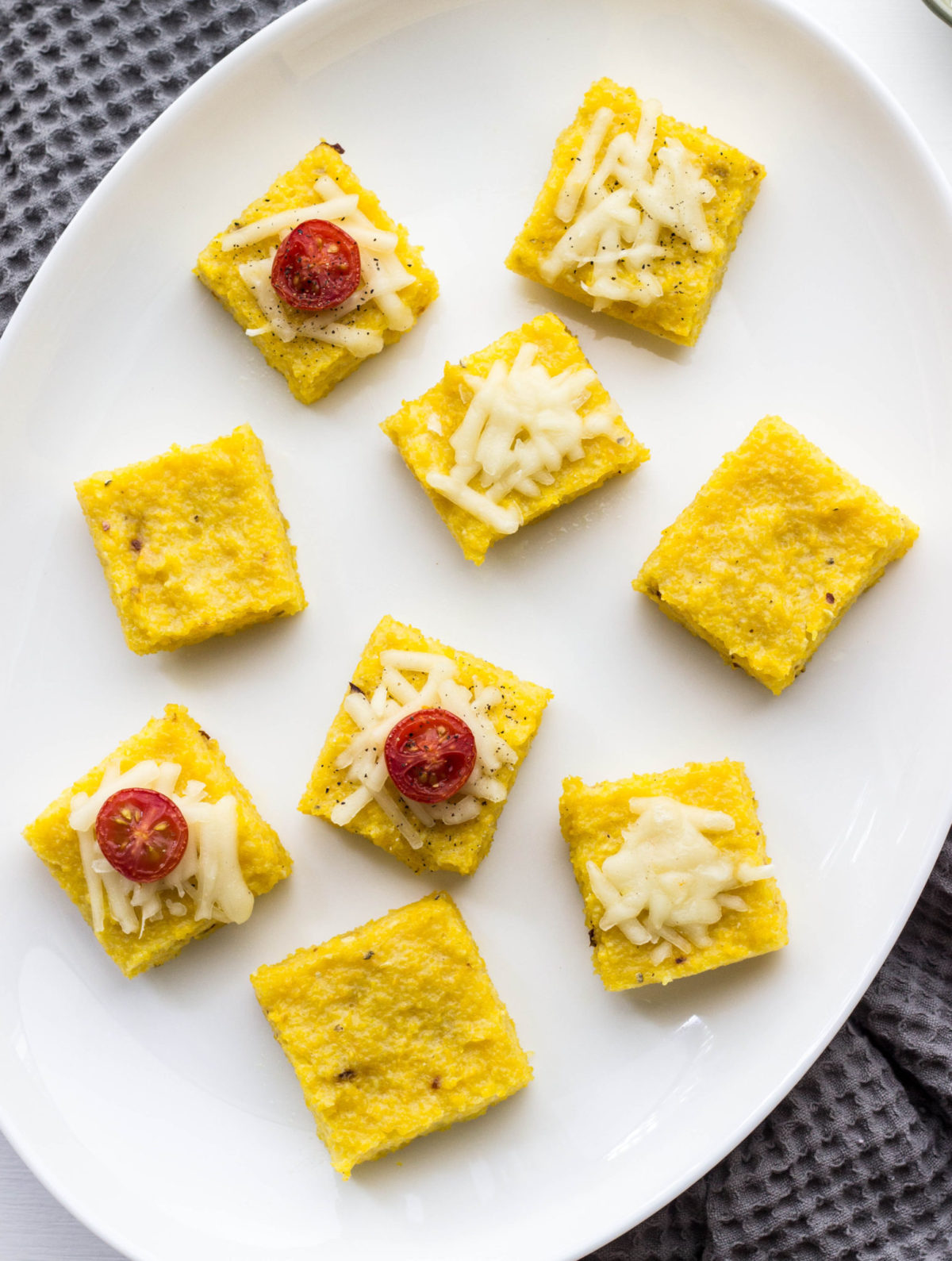 Polenta bites on a white plate. 