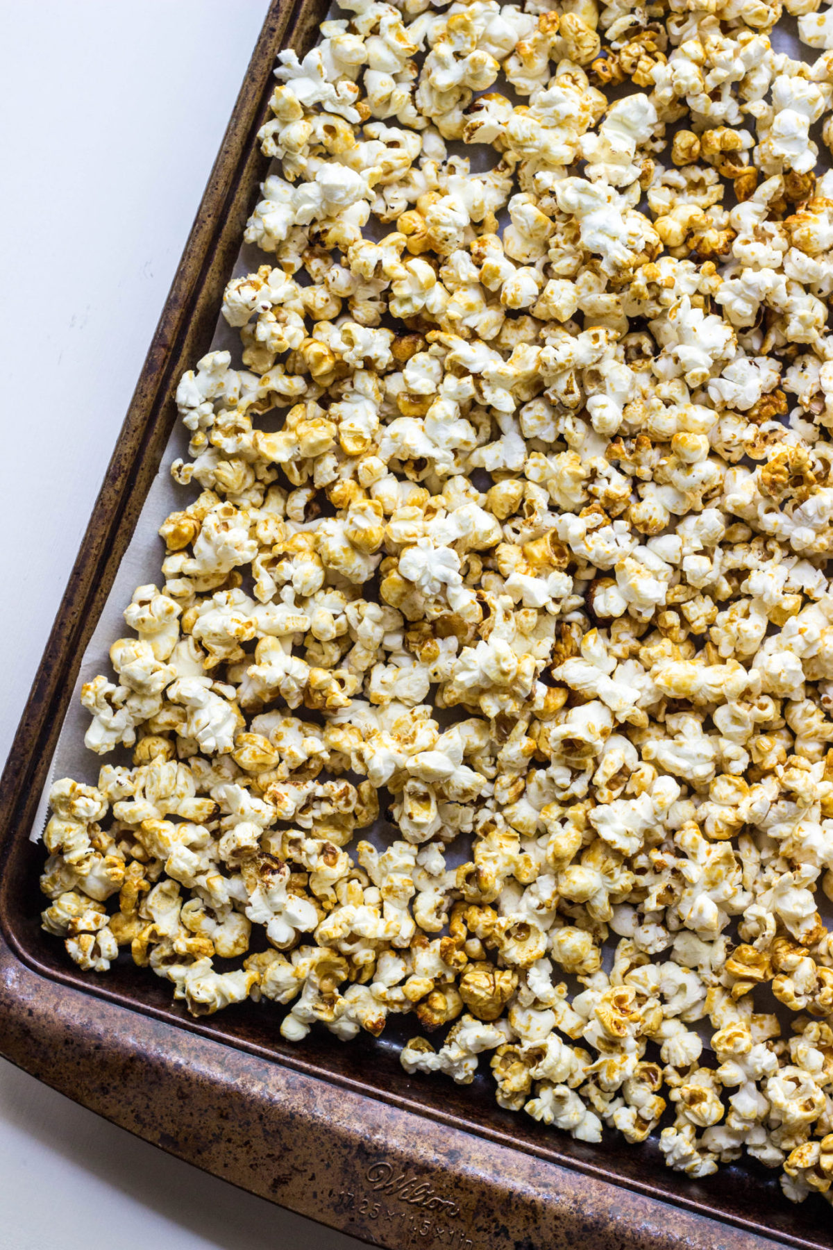Top view of Vegan maple kettle corn on a baking sheet lined with parchment paper.
