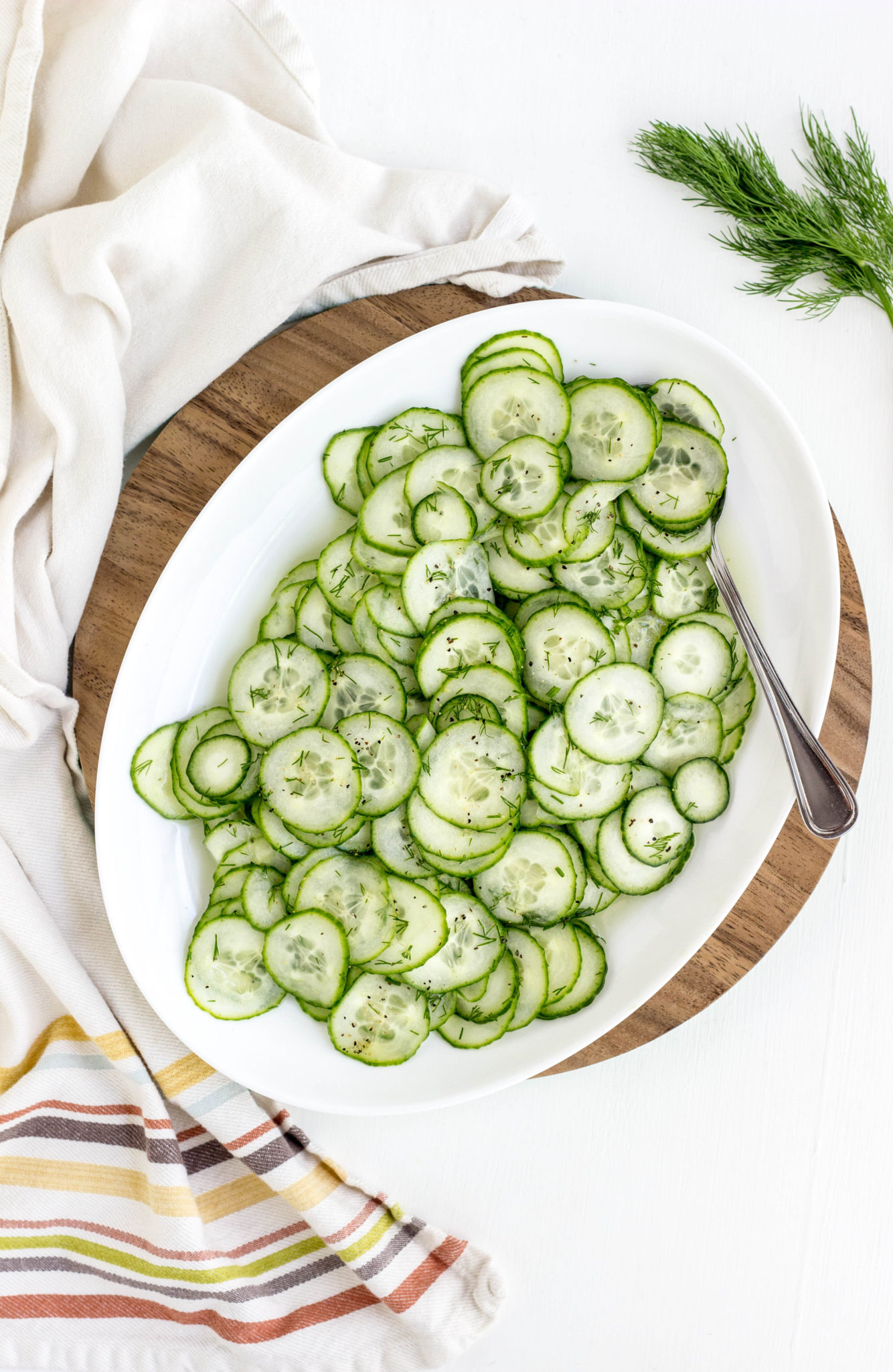 Overhead view of Simple Vegan Cucumber Salad on a white serving plate. 