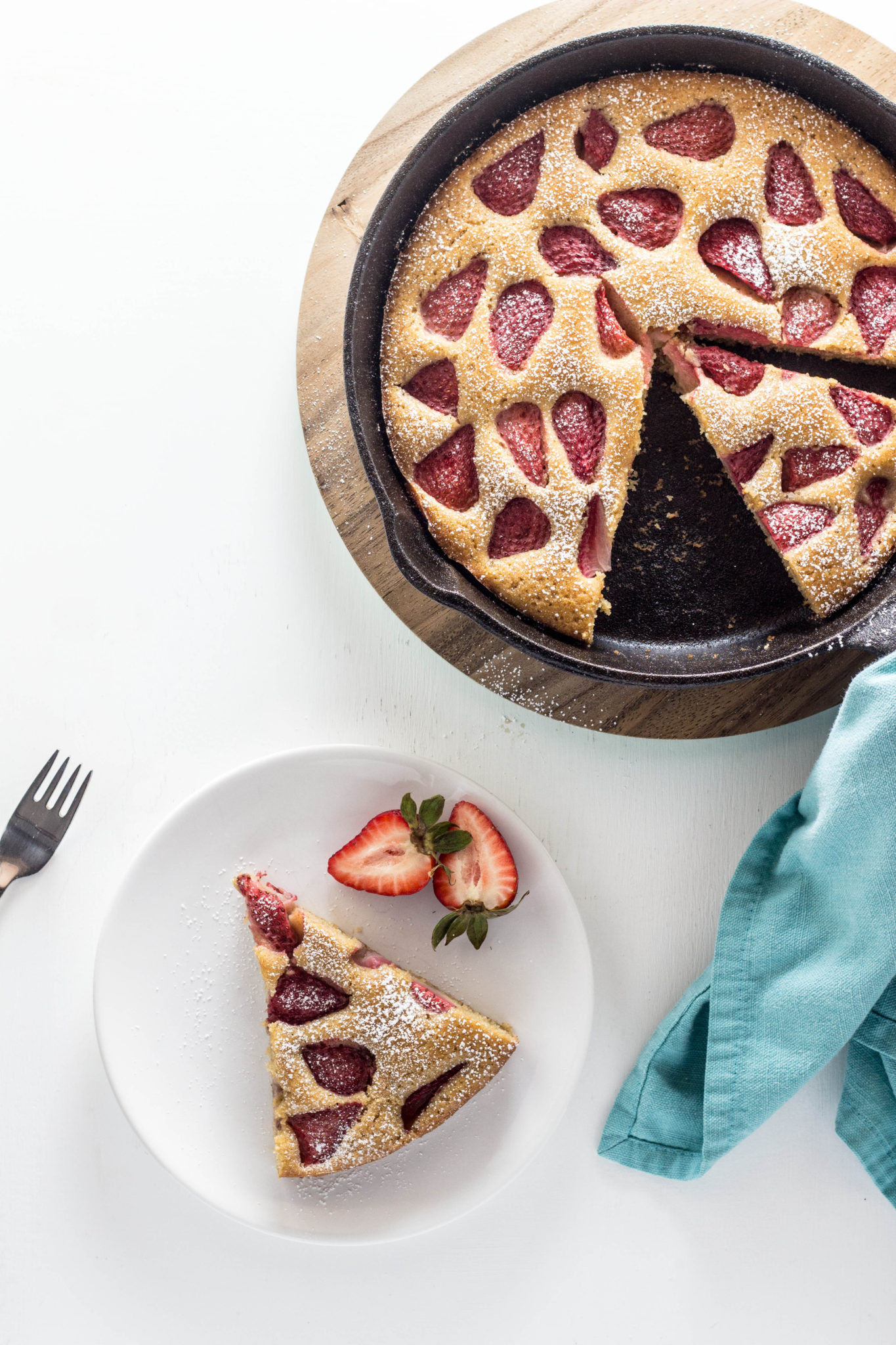 Top view of Vegan Berry Skillet Cake with a slice on a plate. 