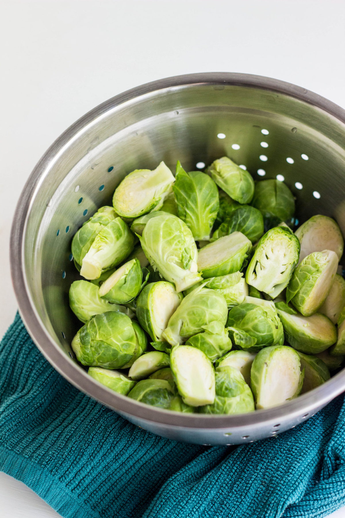 Raw Brussels sprouts in a colander. 