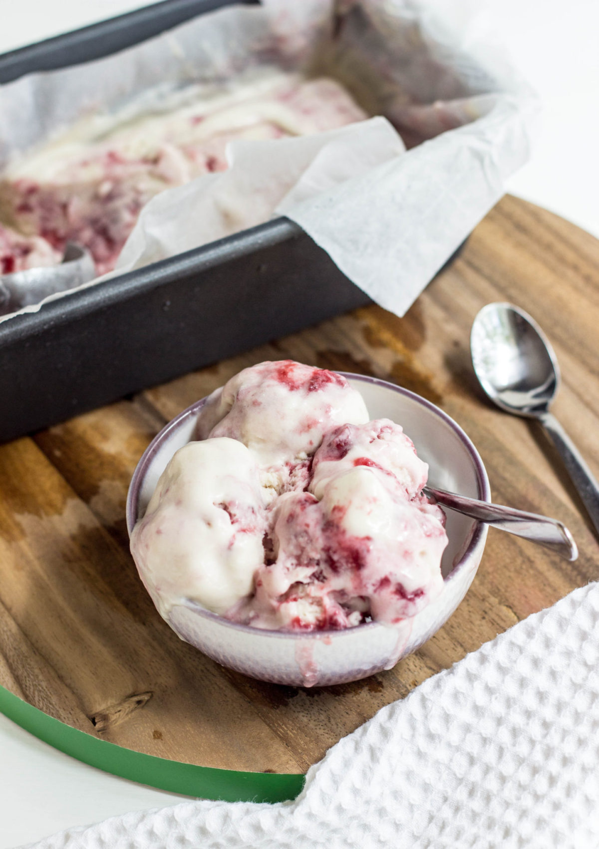 Side View of melty bowl of Strawberry Swirl Ice Cream 