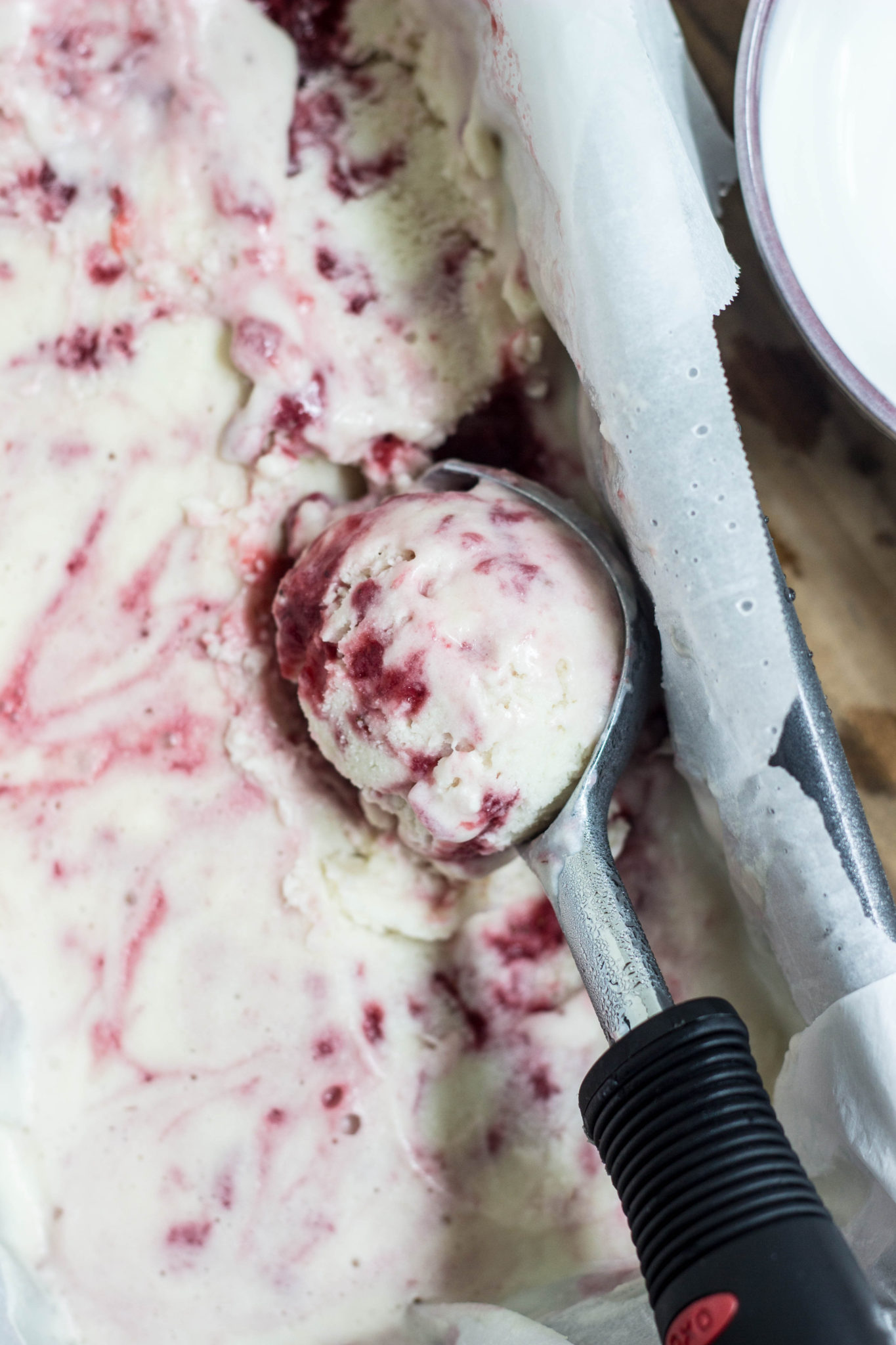 Top view of Strawberry Swirl Ice Cream in ice cream scooper. 