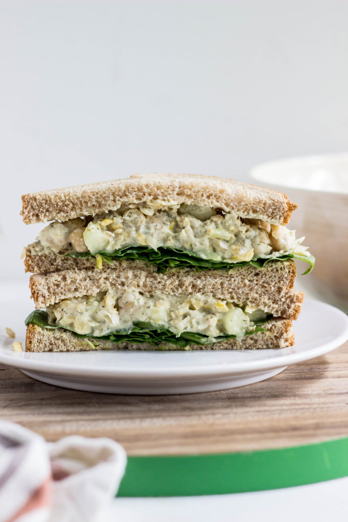 Side view of Cucumber Dill Chickpea Salad sandwich halves stacked. 