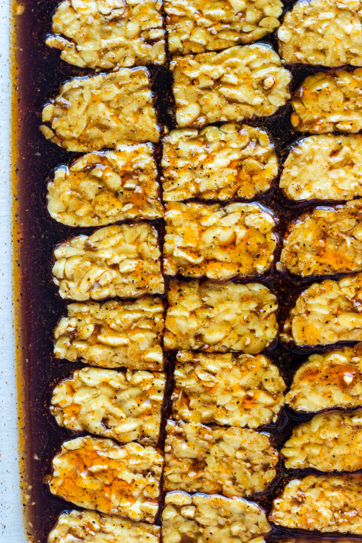 Marinating tempeh up close top view. 