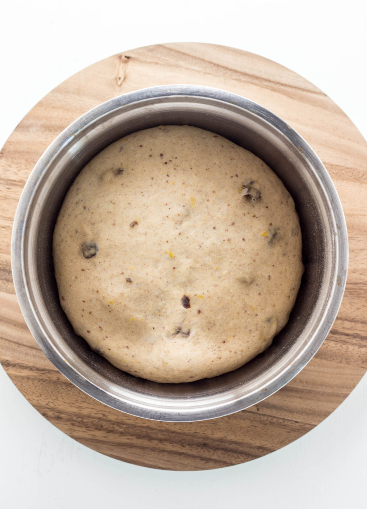 Top view of dough in a metal bowl. 