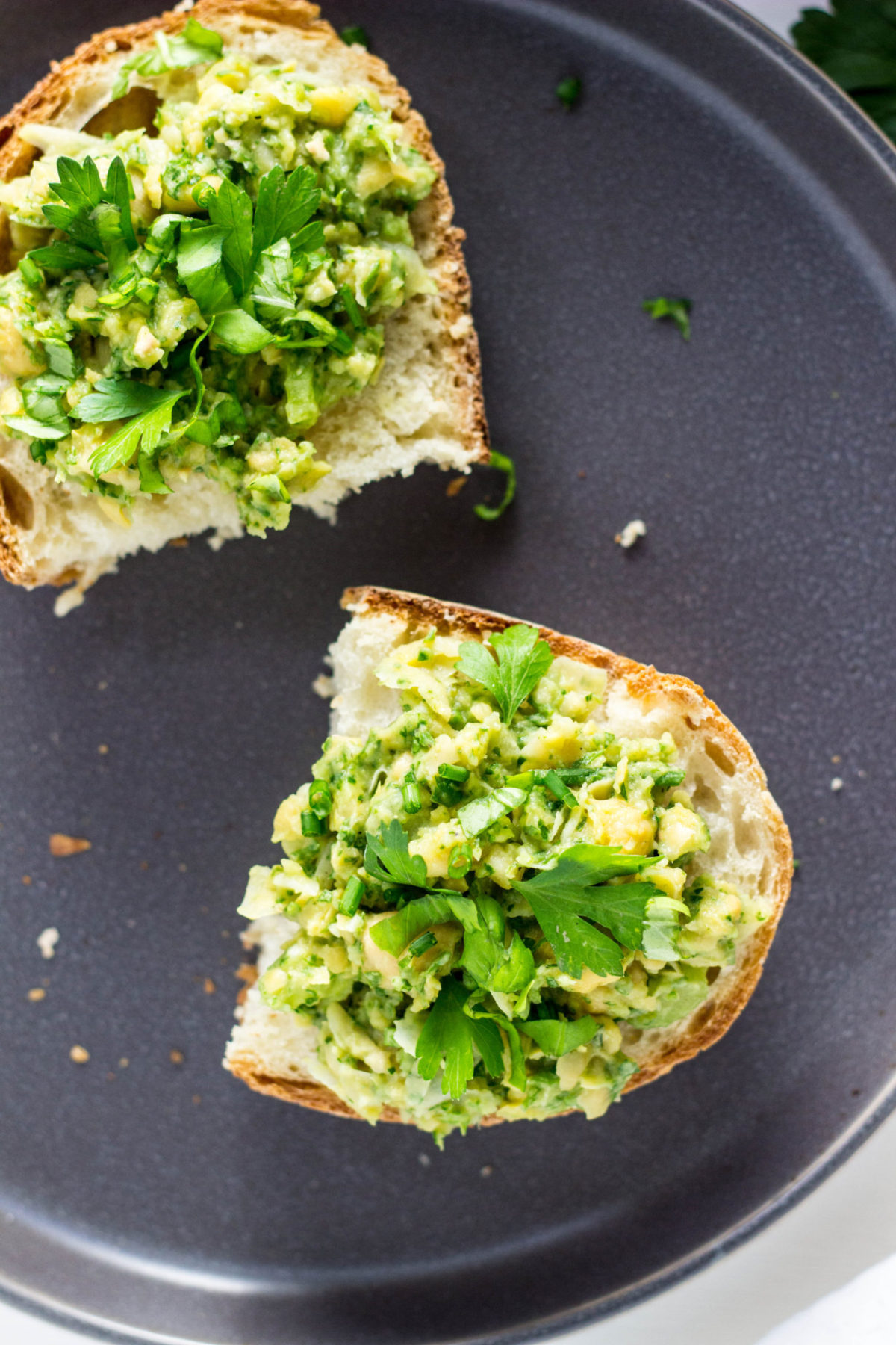 Close up of Herby Chickpea Tartine on gray plate