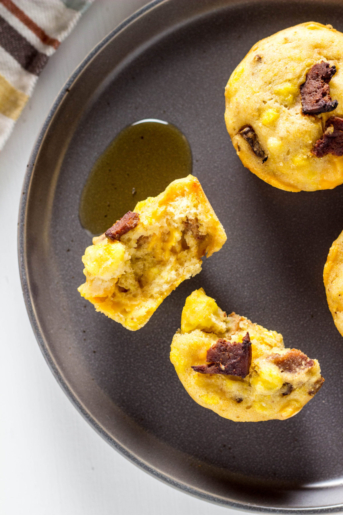 Overhead view of Vegan Breakfast Muffin broken up on a gray plate. 