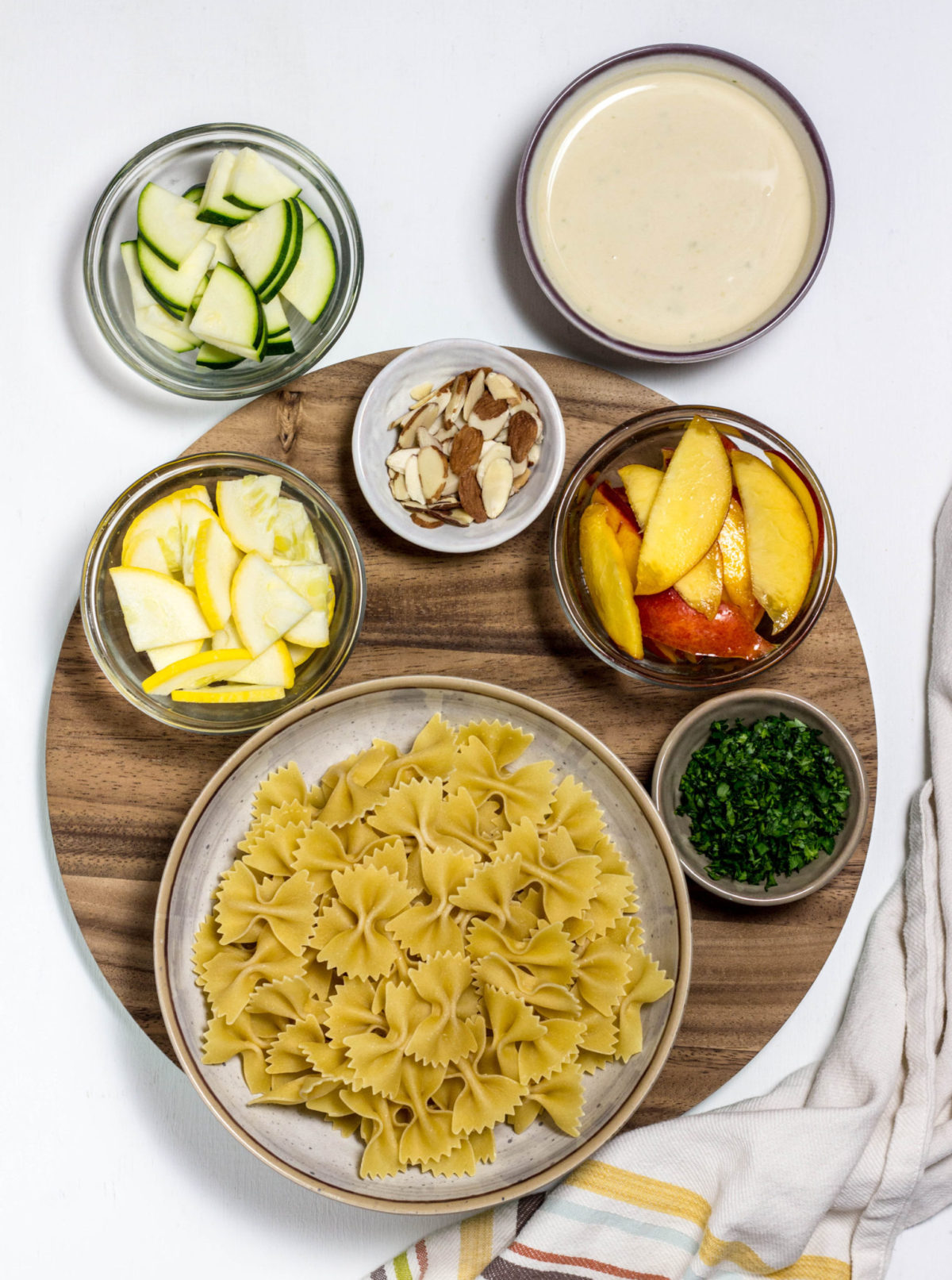 Overhead shot of ingredients for Nectarine Summer Squash Pasta Salad. 