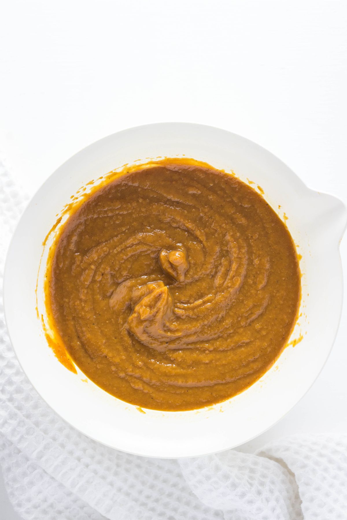 Overhead shot of pumpkin pie filling in a bowl.