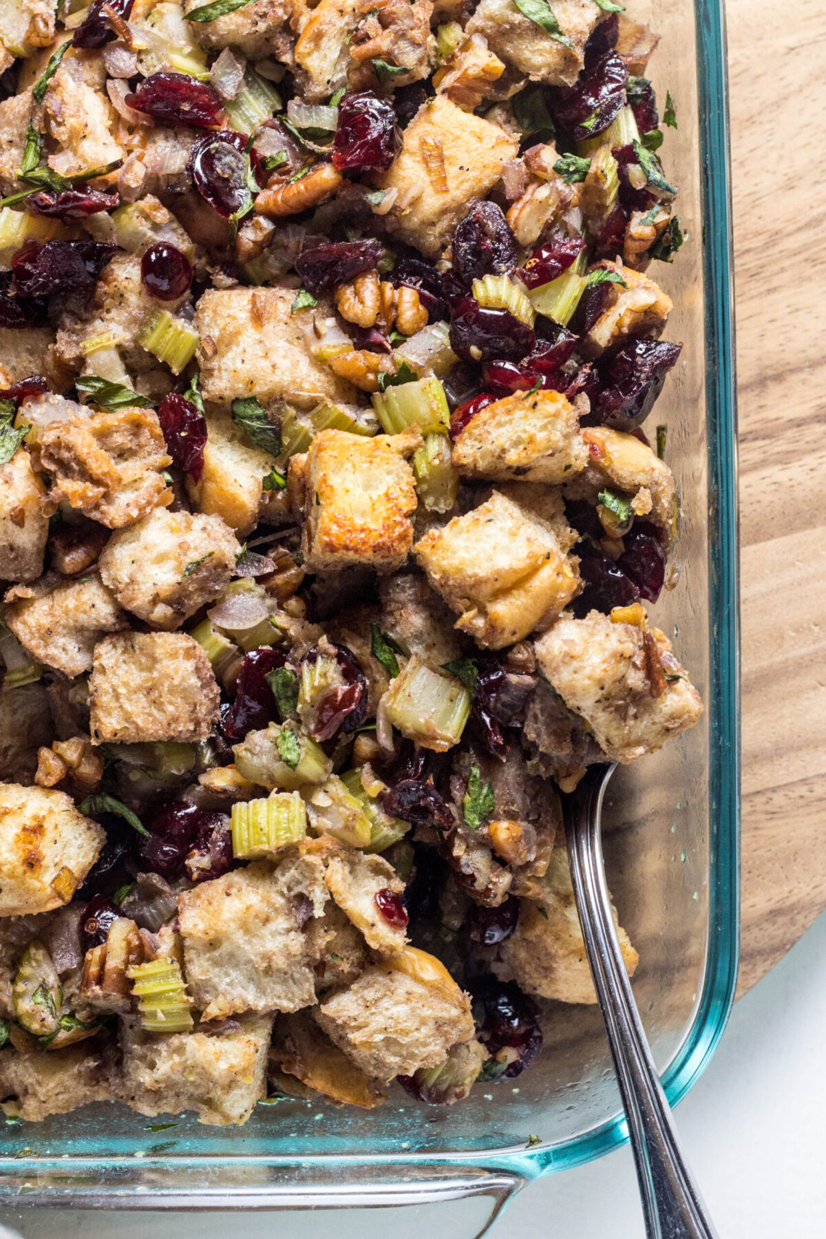 Close up of Vegan Cranberry Pecan Stuffing in a casserole dish.