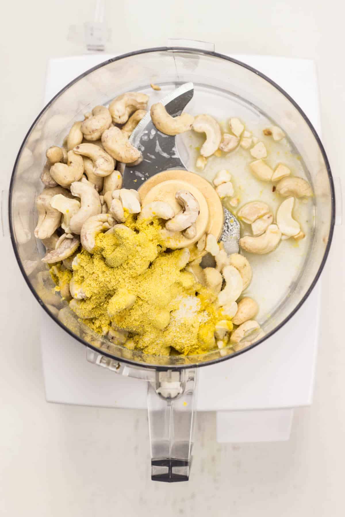 Top view of ingredients to make Cashew Cream Cheese in food processor before blending.