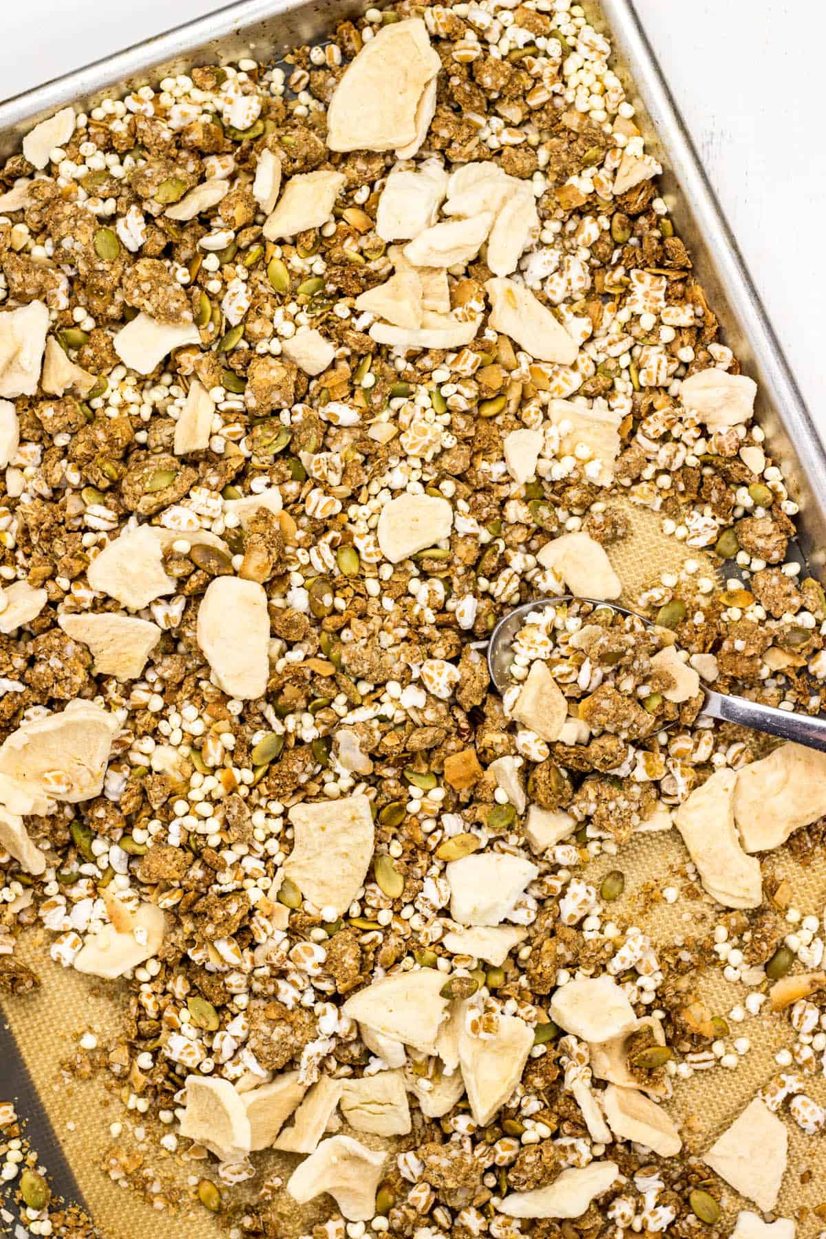 Baked Oat Free Granola on a baking sheet with all mix ins.