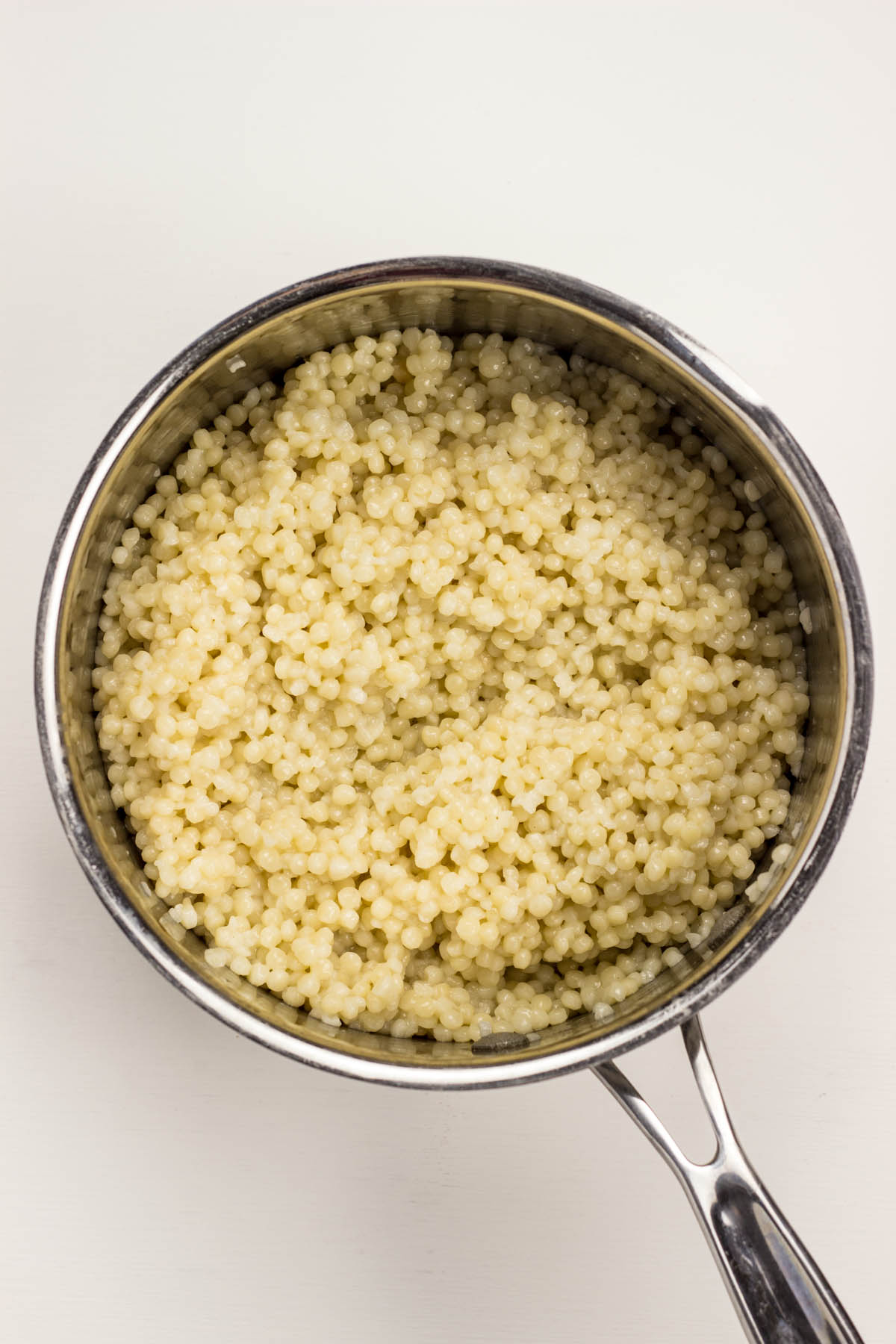 Top view of cooked couscous in a pot.