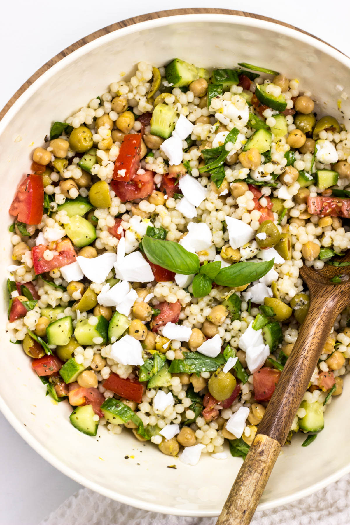 Close up over head view of Vegan Mediterranean Couscous Salad in a bowl.