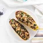 Top view of Millet Stuffed Delicata Squash on a white plate.