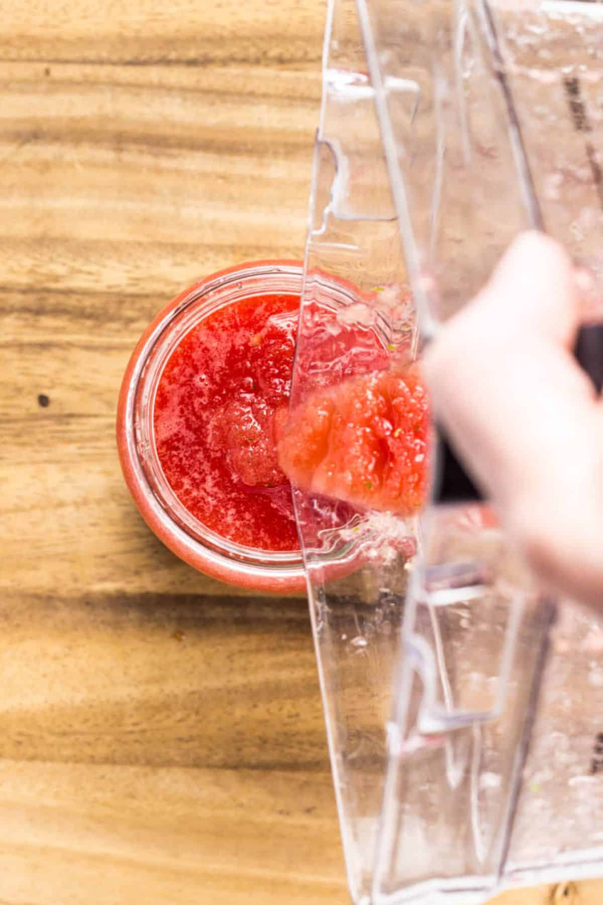 Close up top view pouring Watermelon Basil Slush into a glass.