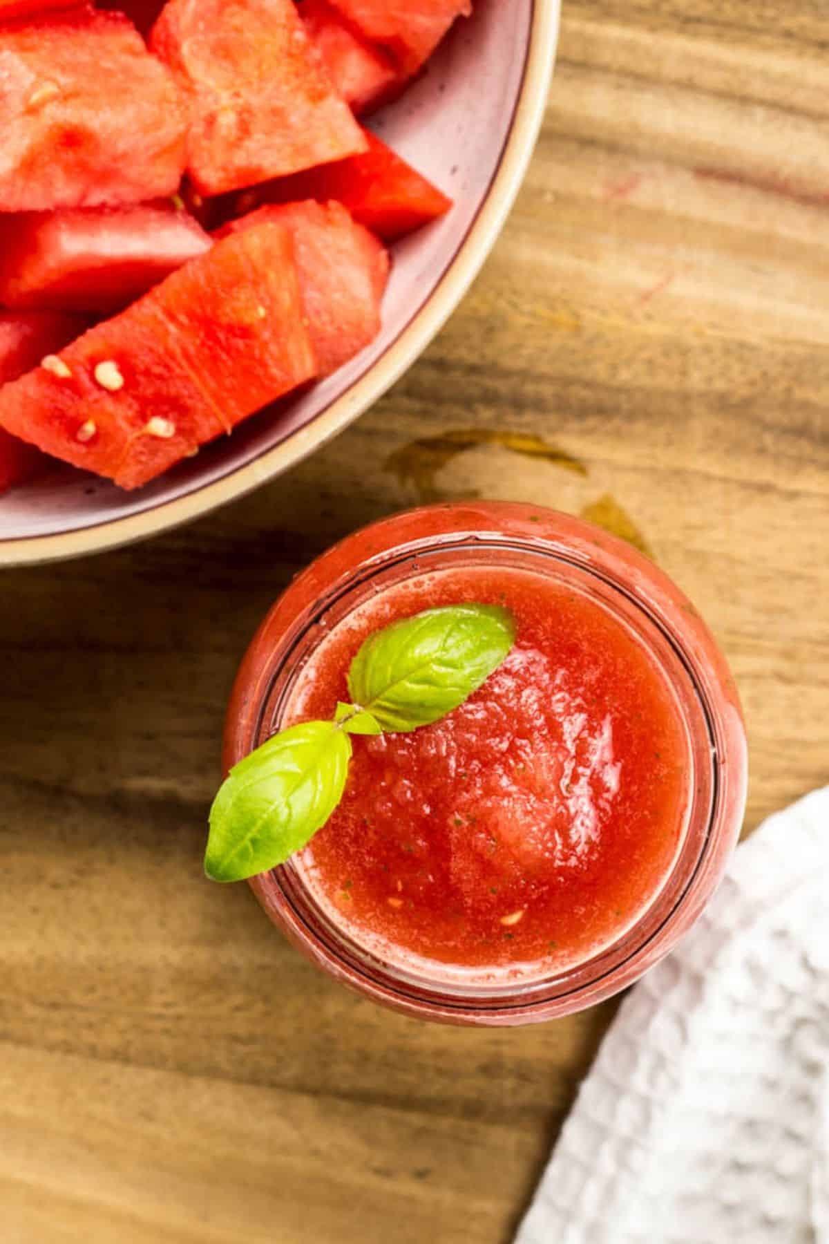 Close up top view of Watermelon Basil Slush with basil garnish.