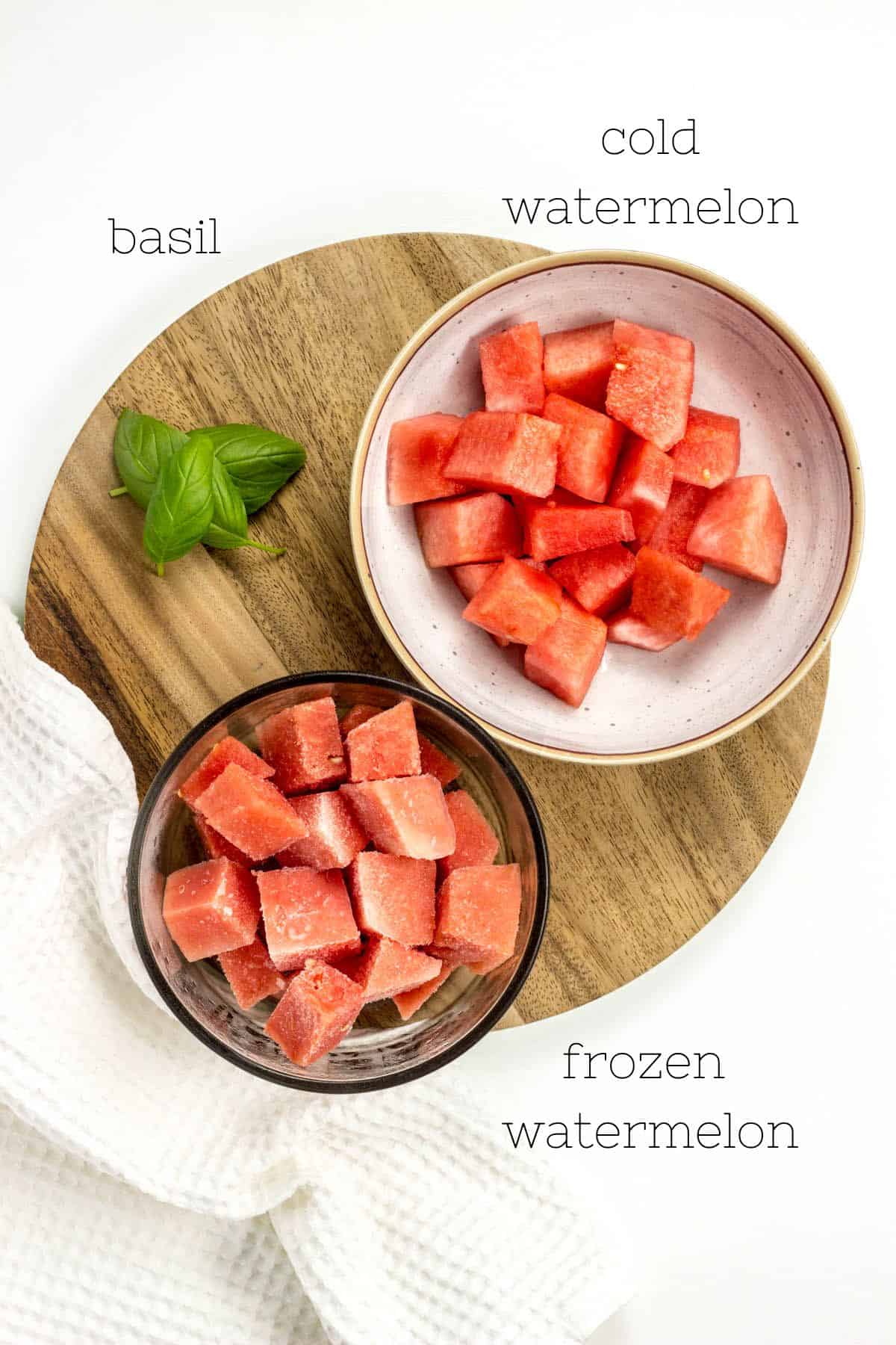 Ingredients for Watermelon Basil Slush on a wooden cutting board.