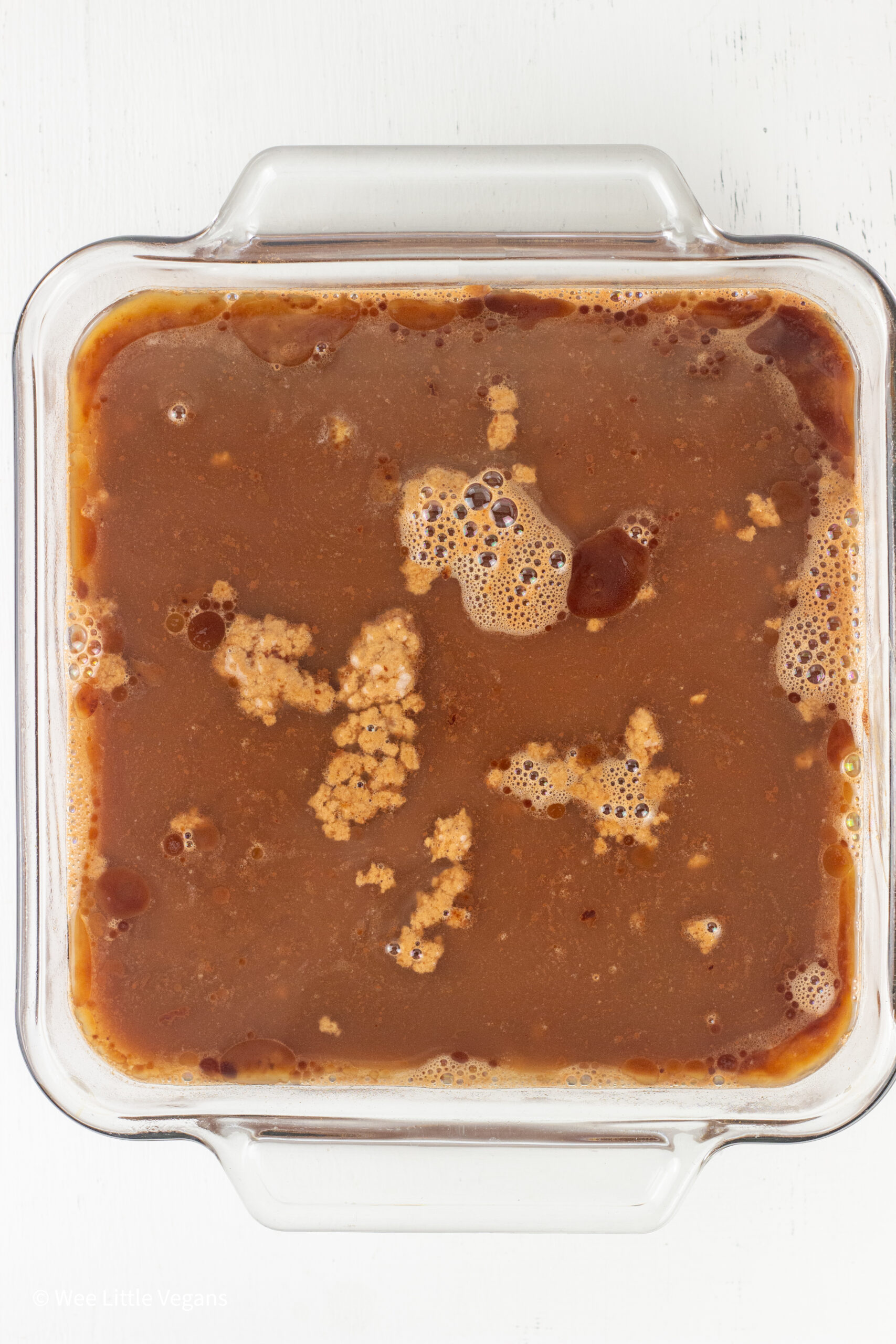 Overhead shot of baking dish filled with batter and hot water for cobbler.