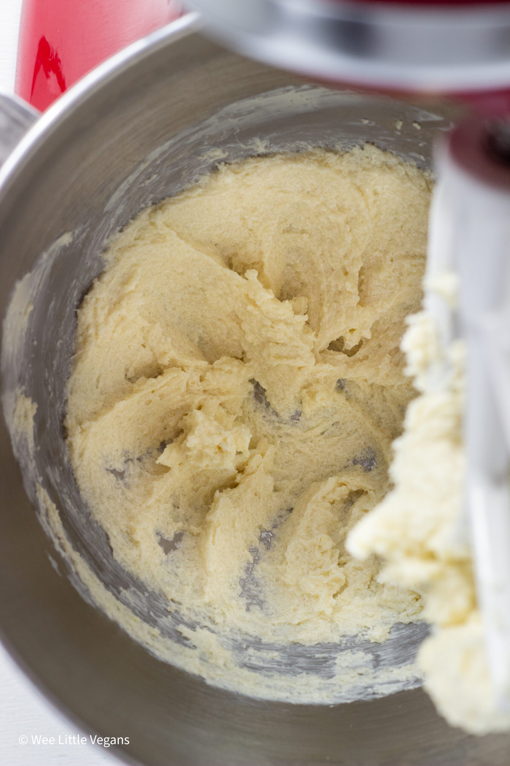 Close up of butter and sugar creamed together in a mixing bowl.
