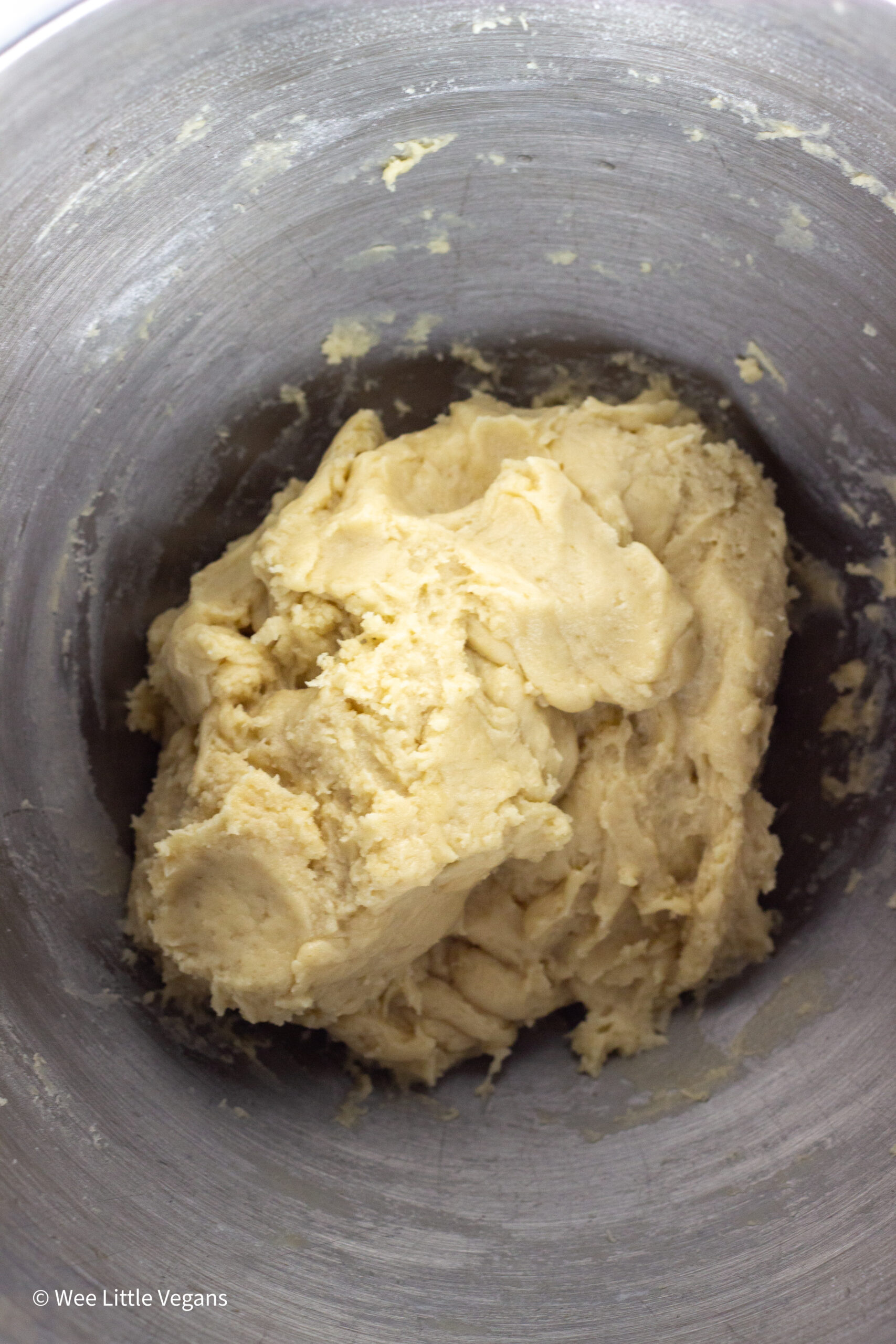 Overhead shot of dough in mixing bowl.